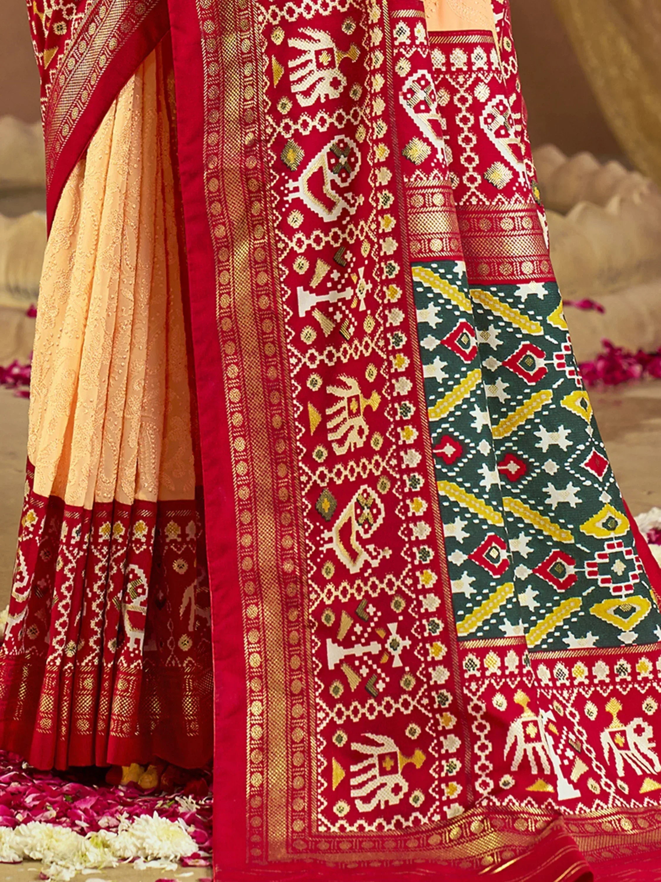 Red and gold ethnic saree with intricate elephant and geometric patterns, perfect for Indian weddings and festivals.