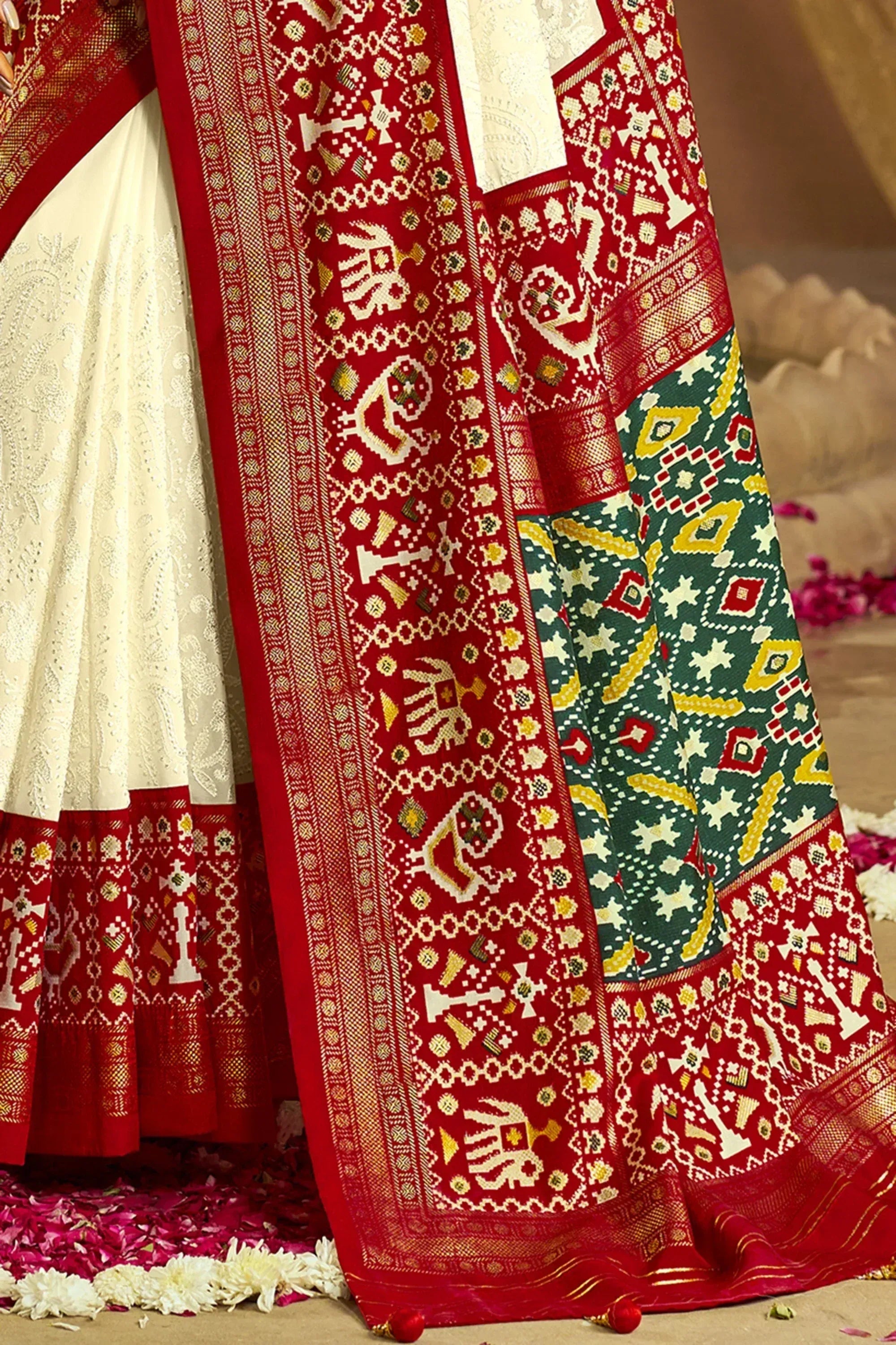 Red and cream ethnic saree with intricate elephant and geometric patterns, perfect for Indian weddings and festivals.