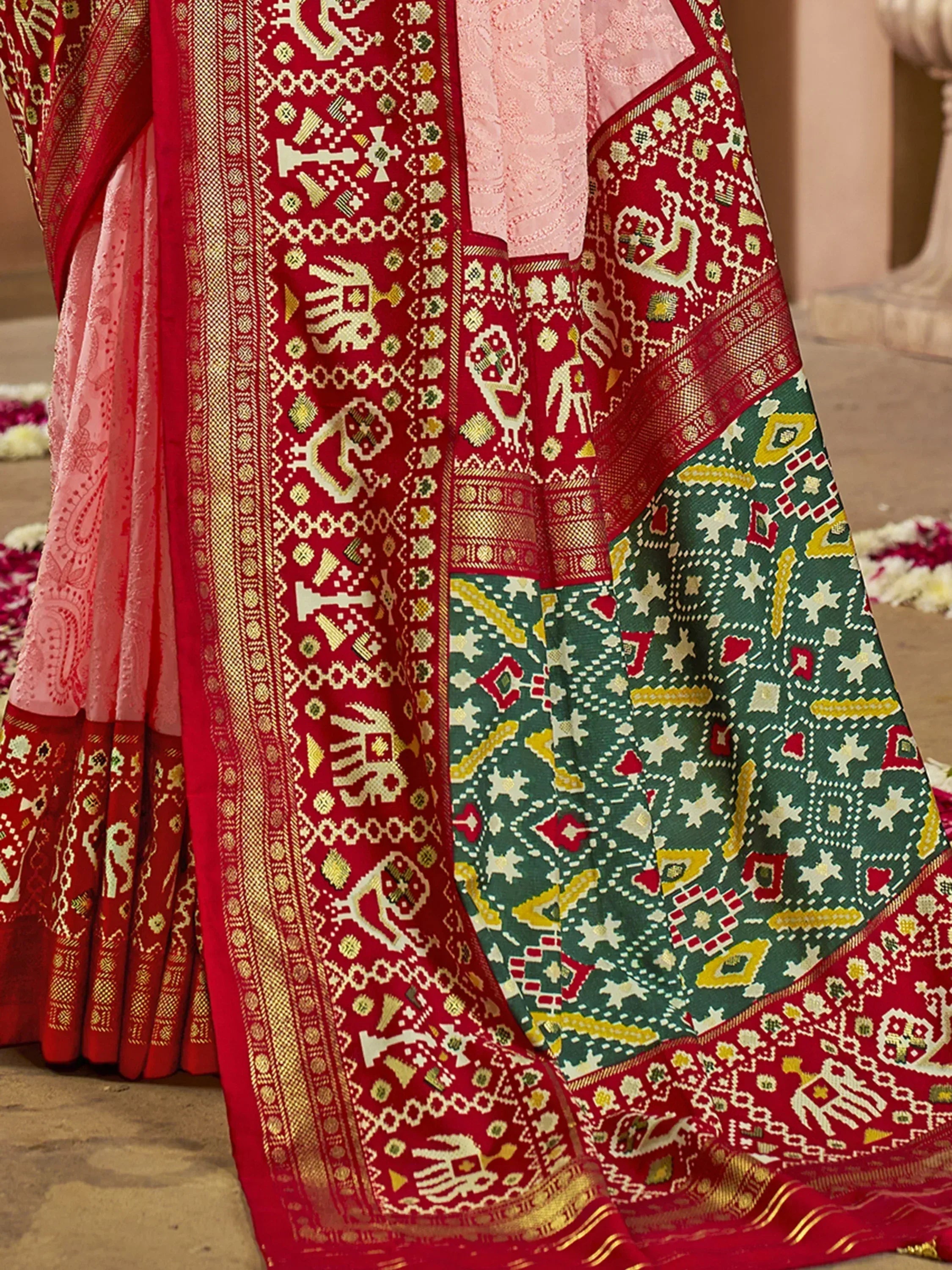 Red and green ethnic saree with intricate elephant and geometric patterns, perfect for Indian festive occasions.