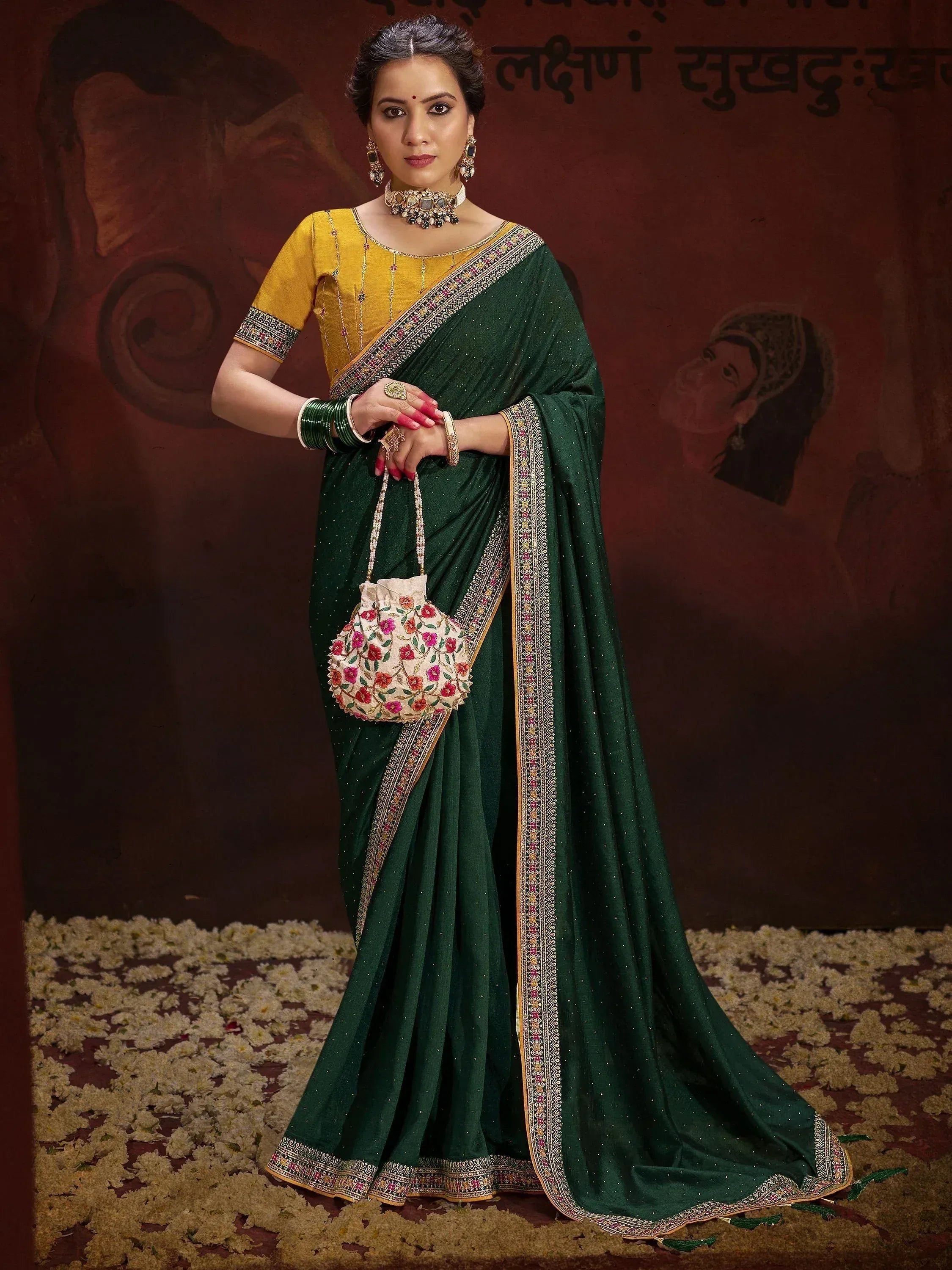 Elegant green saree with gold border, yellow blouse, floral potli bag, traditional Indian ethnic wear