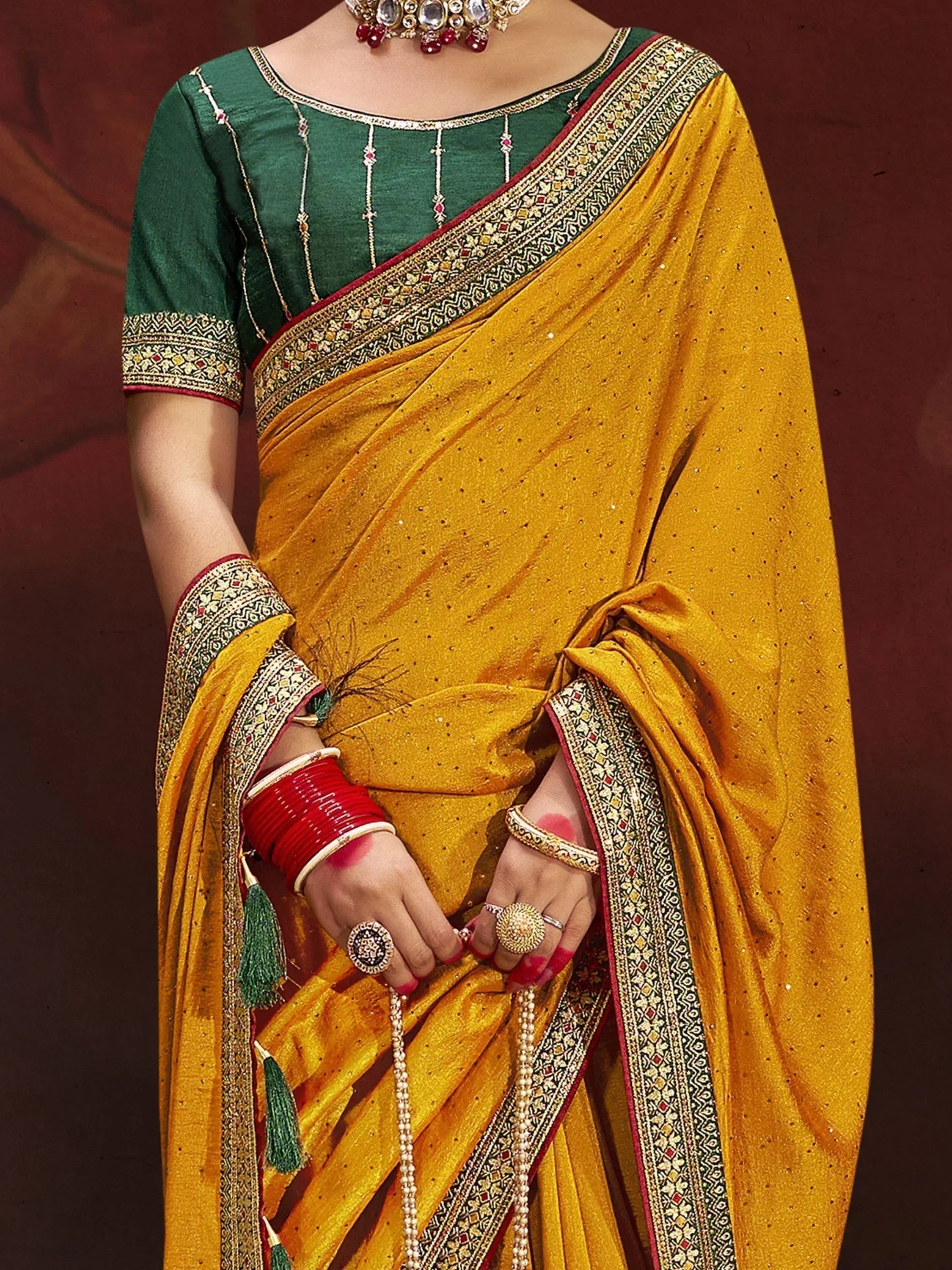Yellow saree with green blouse, embroidered border, and traditional jewelry for Indian ethnic wear