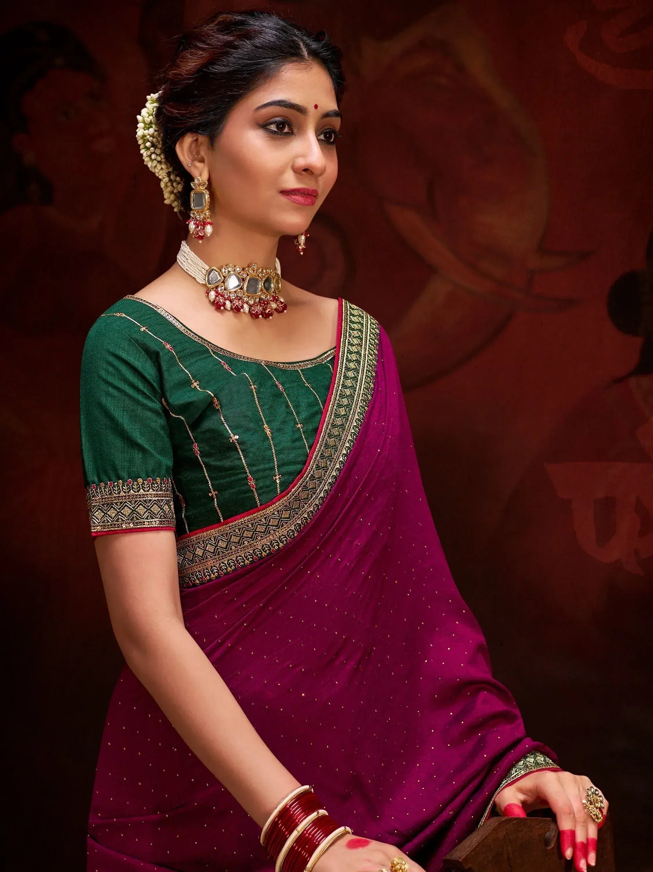 Elegant woman in purple saree with green blouse, traditional Indian ethnic wear, adorned with jewelry