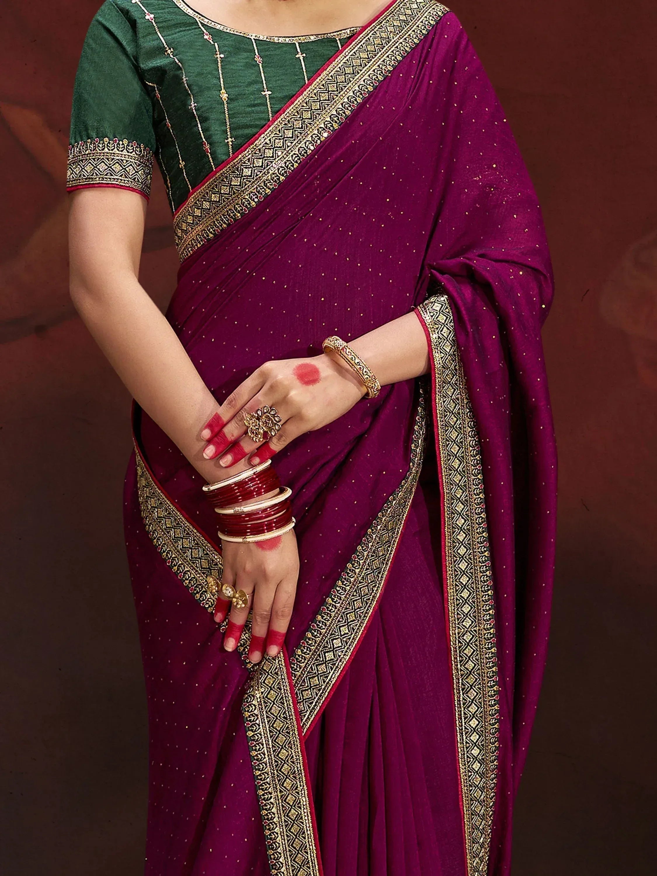 Purple saree with gold border and green blouse, ethnic Indian wear with traditional jewelry