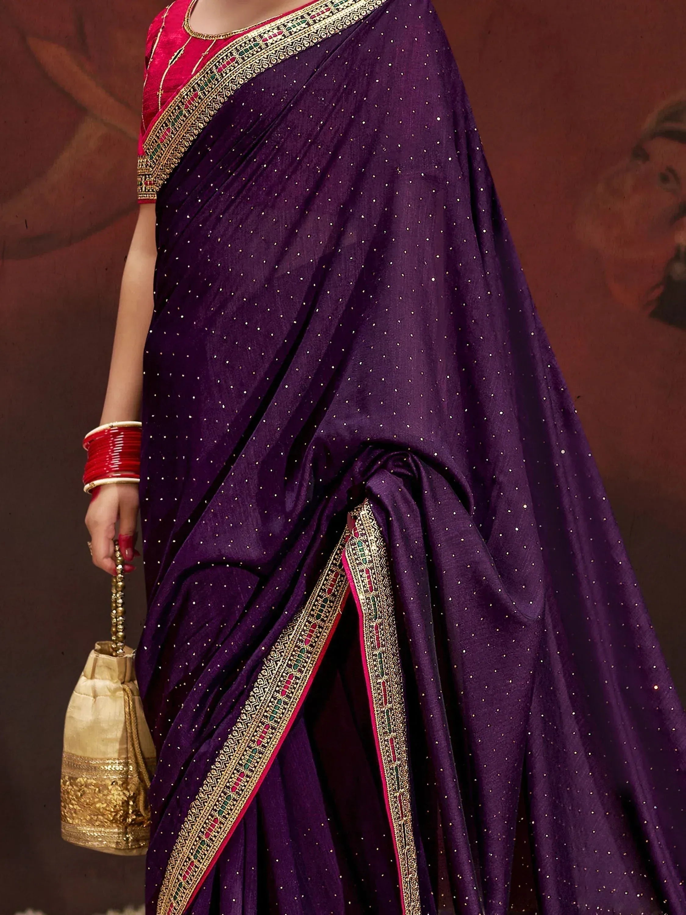 Purple ethnic saree with gold embroidery and pink blouse, perfect for Indian weddings and festive occasions.