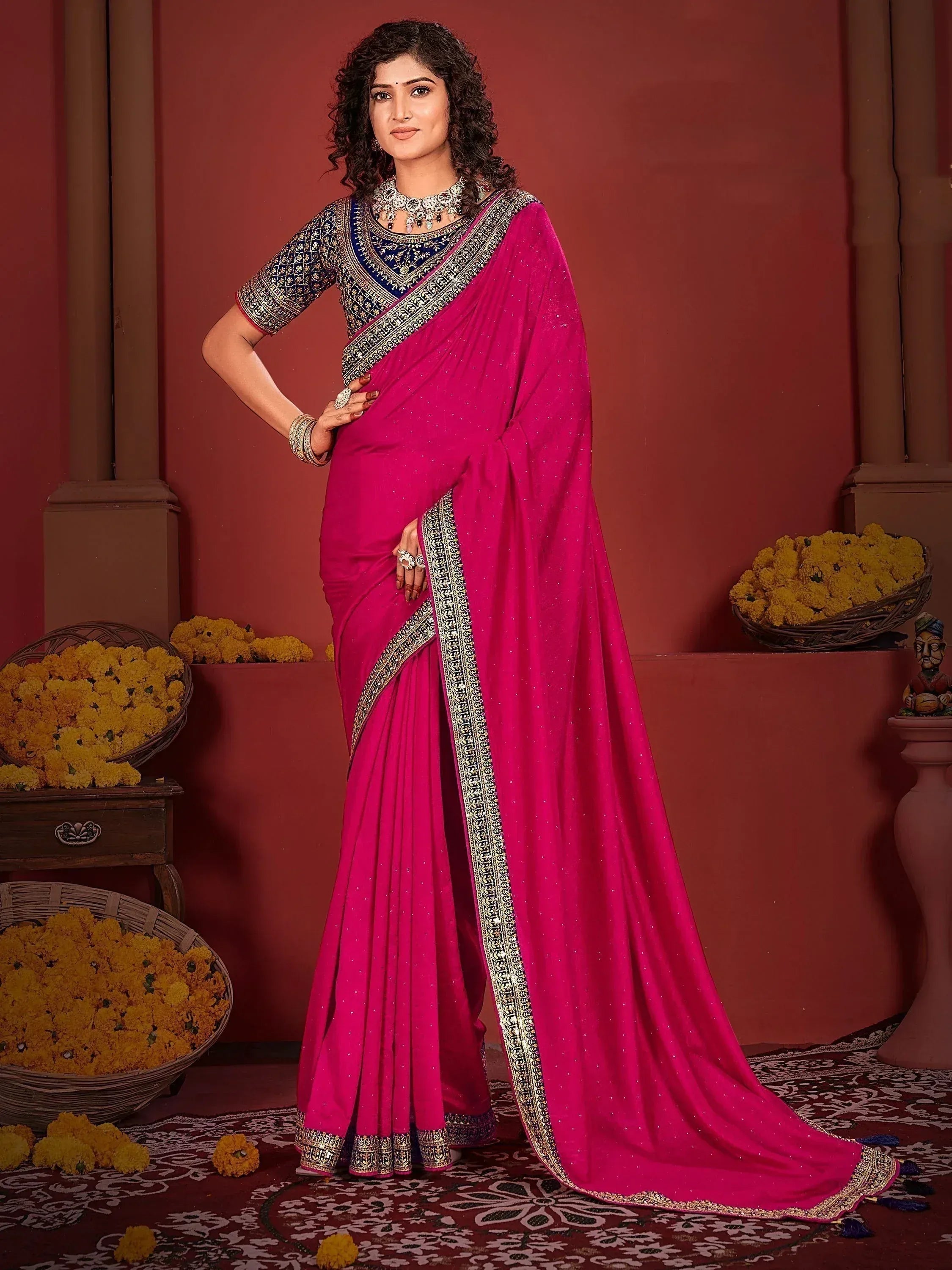 Fuchsia saree with gold border and embroidered navy blue blouse, styled for Indian ethnic wear
