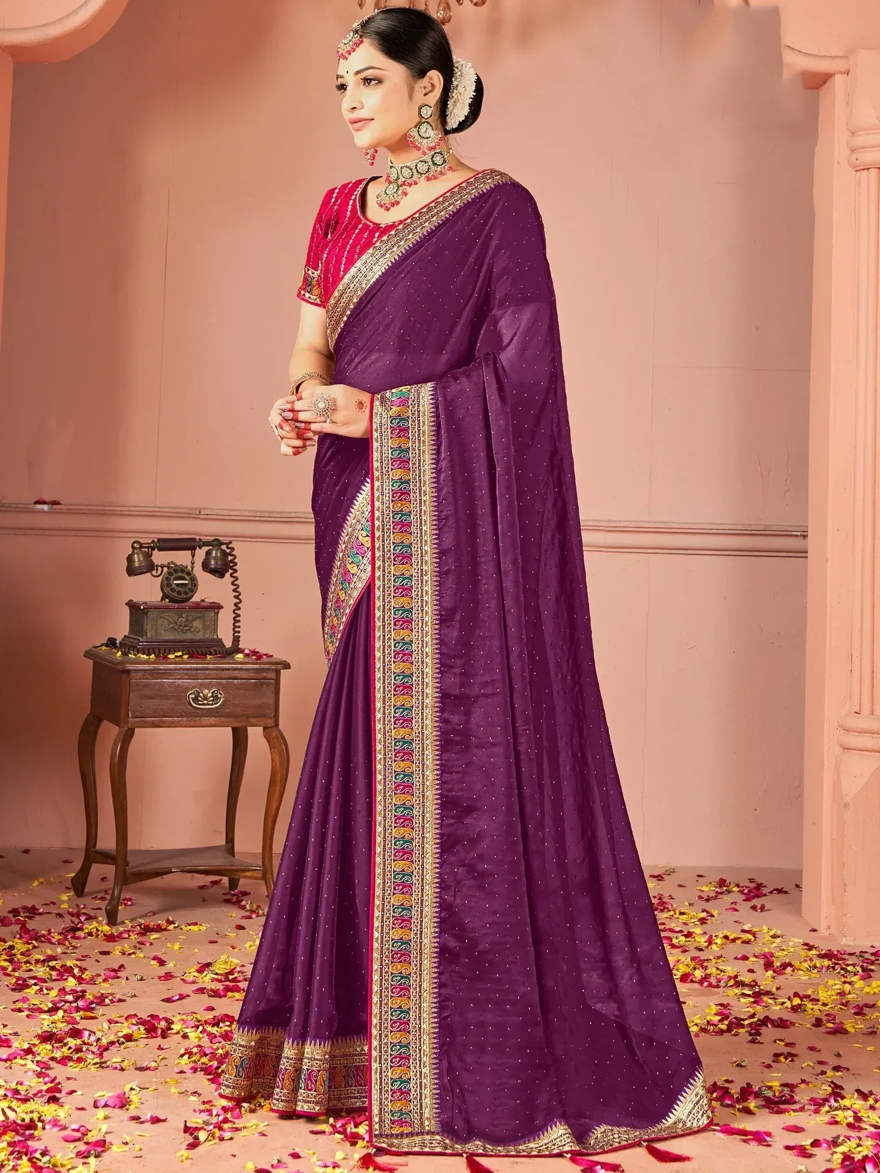 Purple ethnic saree with colorful border, paired with red blouse, perfect for Indian celebrations