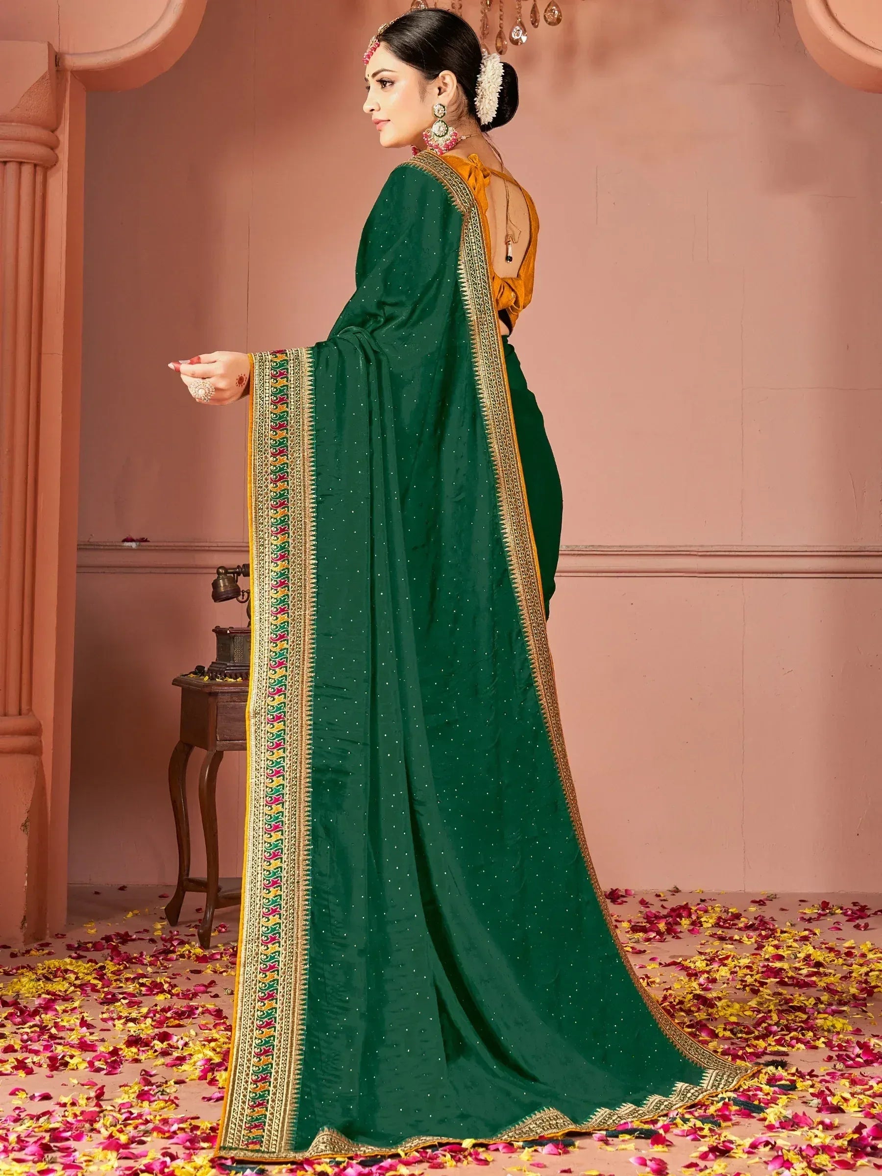 Emerald green saree with golden border and floral motifs, paired with yellow blouse, perfect for Indian ethnic occasions.