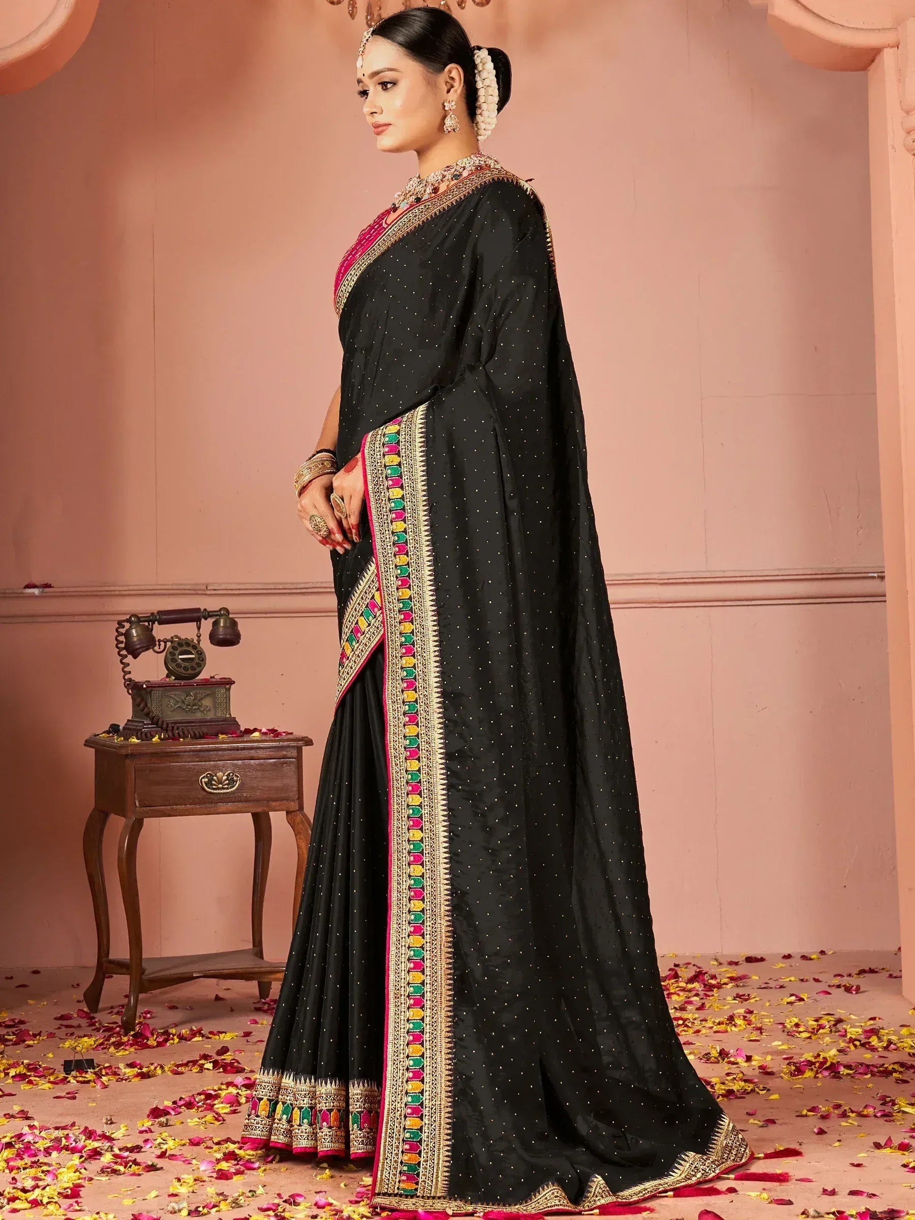 Black designer saree with colorful embroidered border, perfect for Indian ethnic wear and festive occasions.