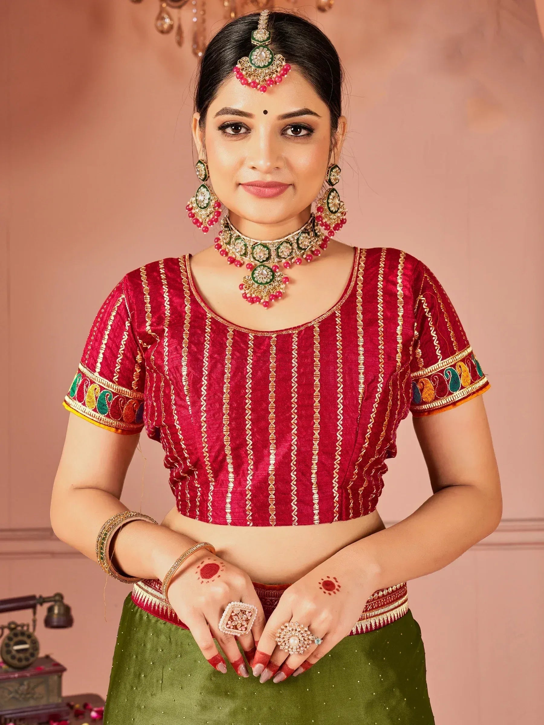Red embroidered blouse with green skirt, traditional Indian ethnic wear, matching jewelry set