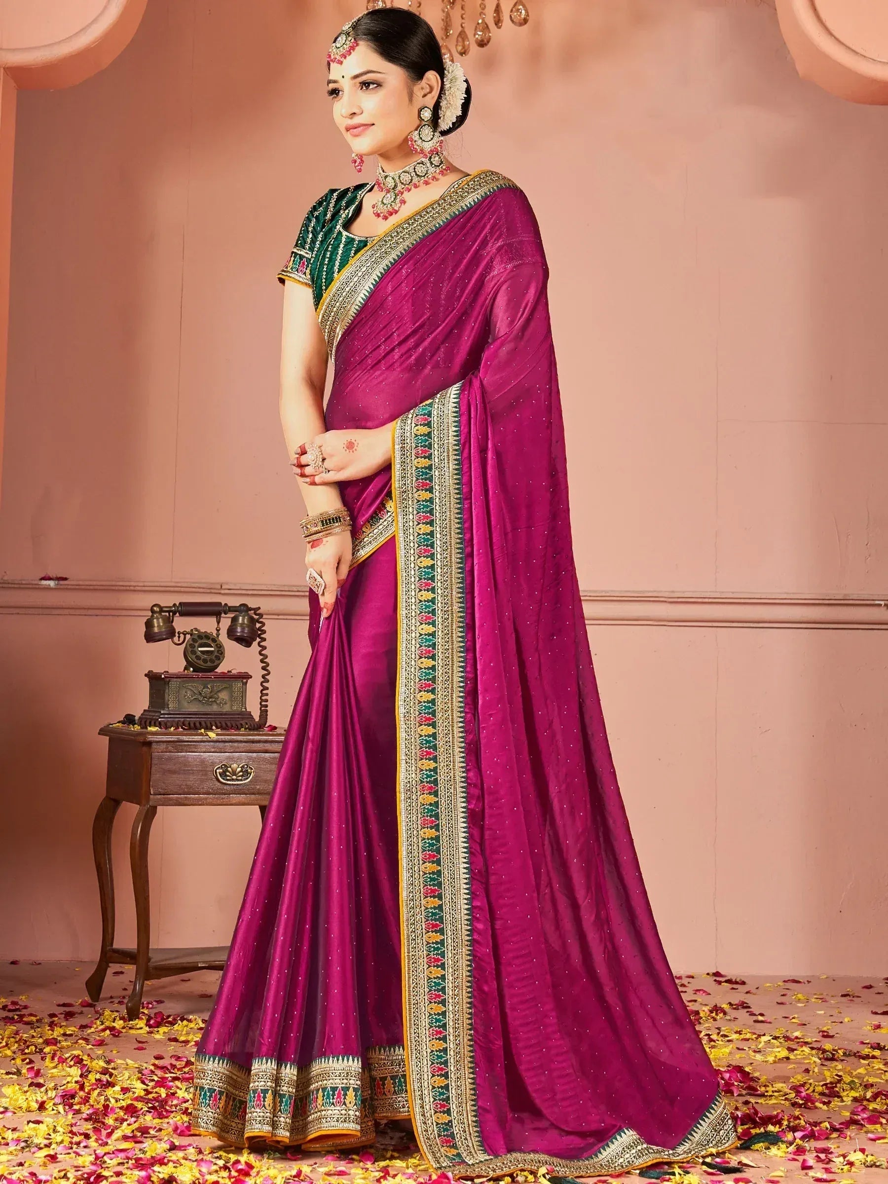 Purple Indian saree with green blouse, embroidered border, and traditional jewelry for ethnic wear