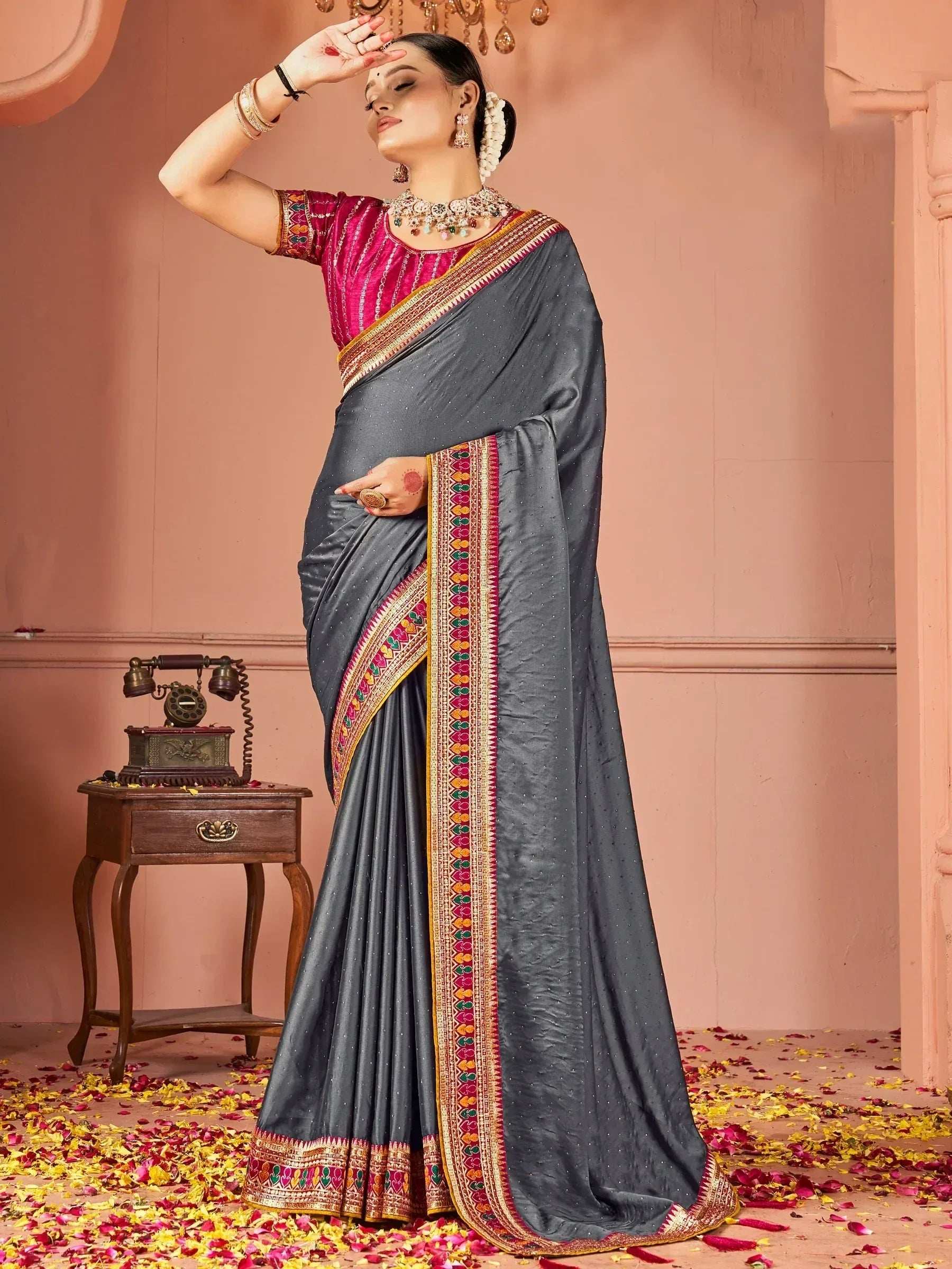 Grey saree with colorful embroidered border and pink blouse, styled with traditional jewelry for ethnic wear
