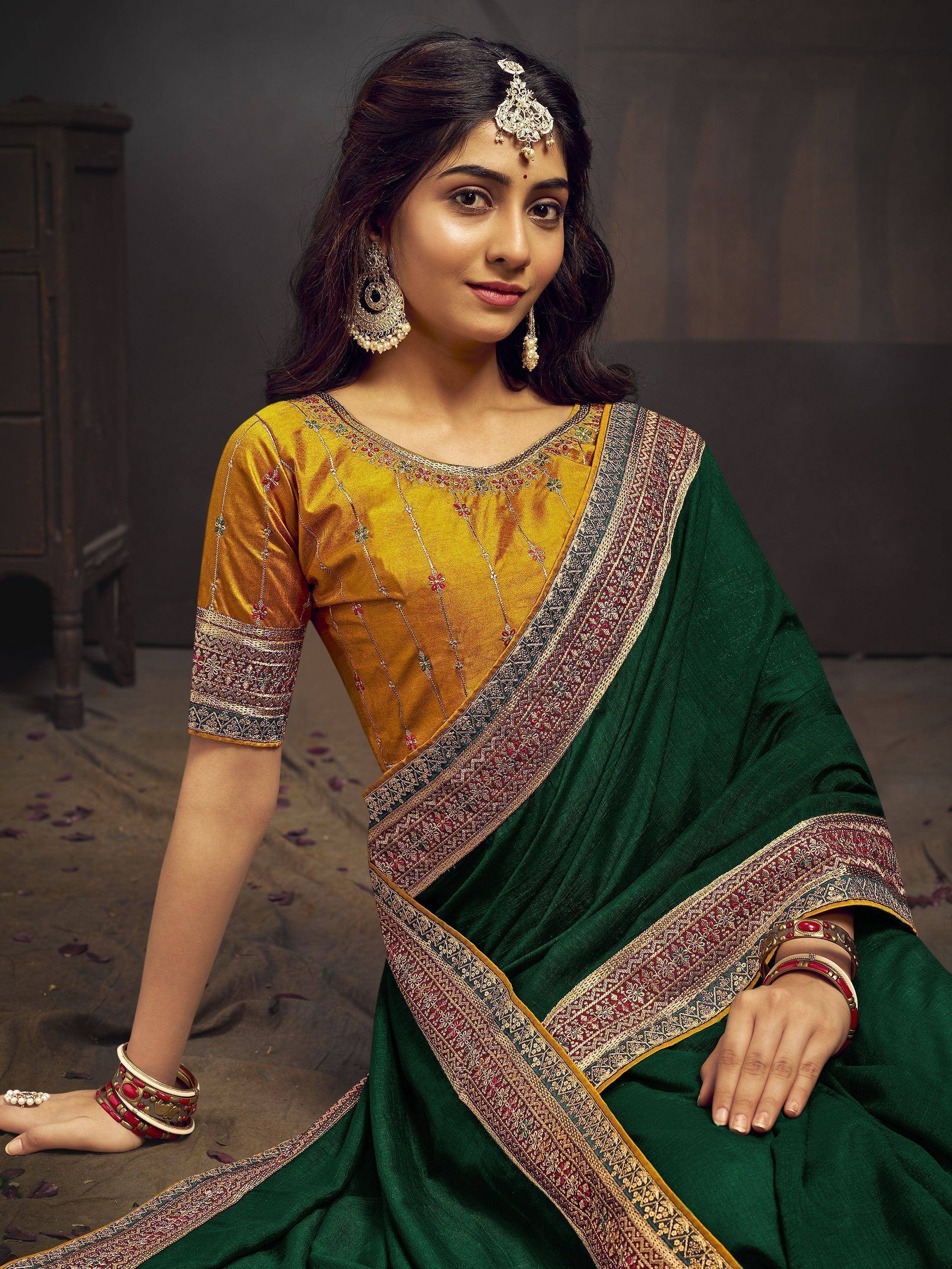 Woman in green saree with gold blouse, traditional Indian ethnic wear, festive designer saree with intricate border