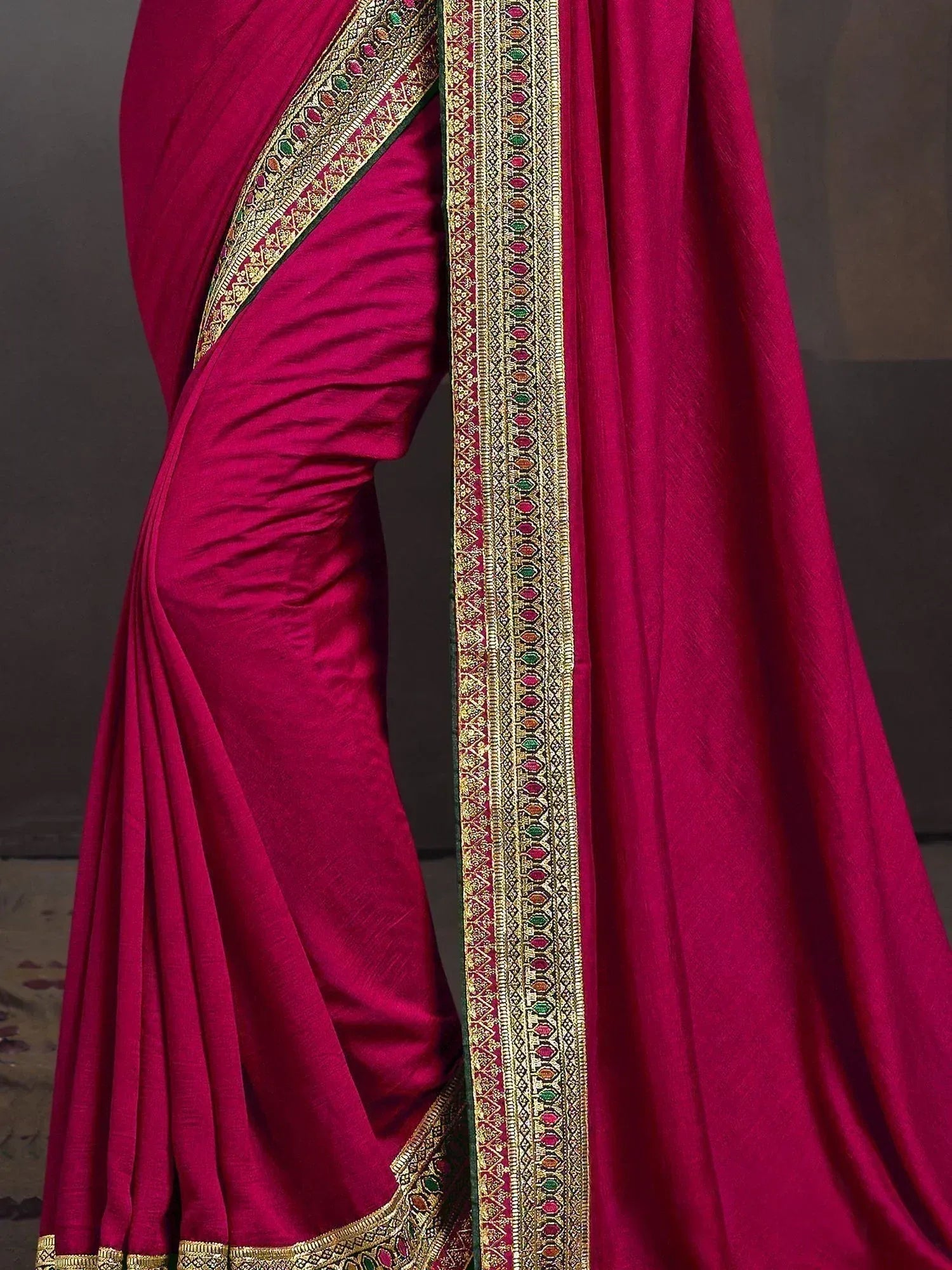 Rich magenta saree with intricate gold and multicolor border, perfect for Indian ethnic occasions
