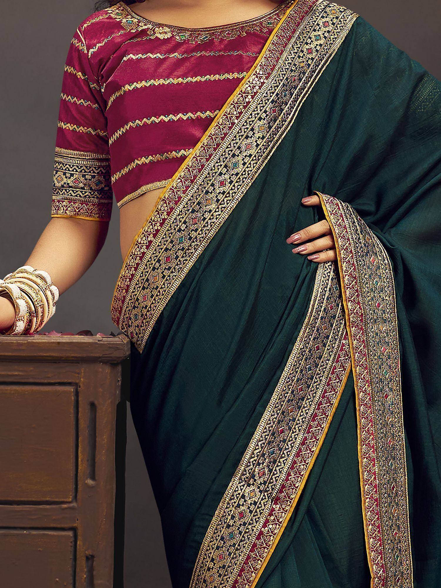 Emerald green saree with gold and maroon border, paired with embroidered magenta blouse for Indian ethnic wear