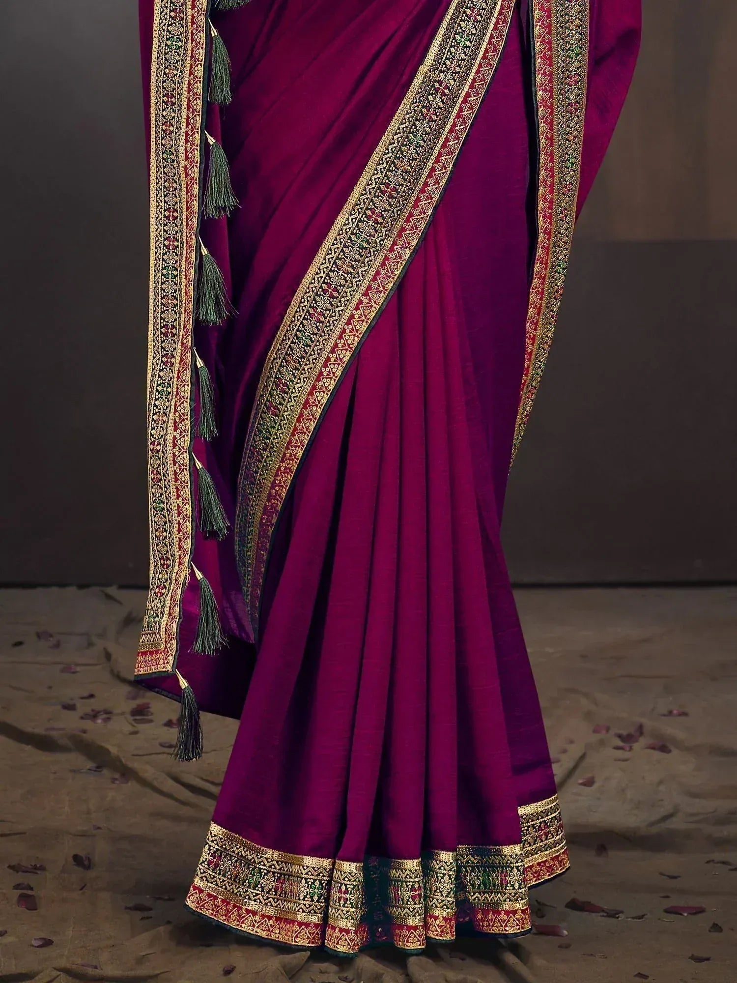 Rich purple ethnic saree with gold border and tassels, perfect for Indian occasions