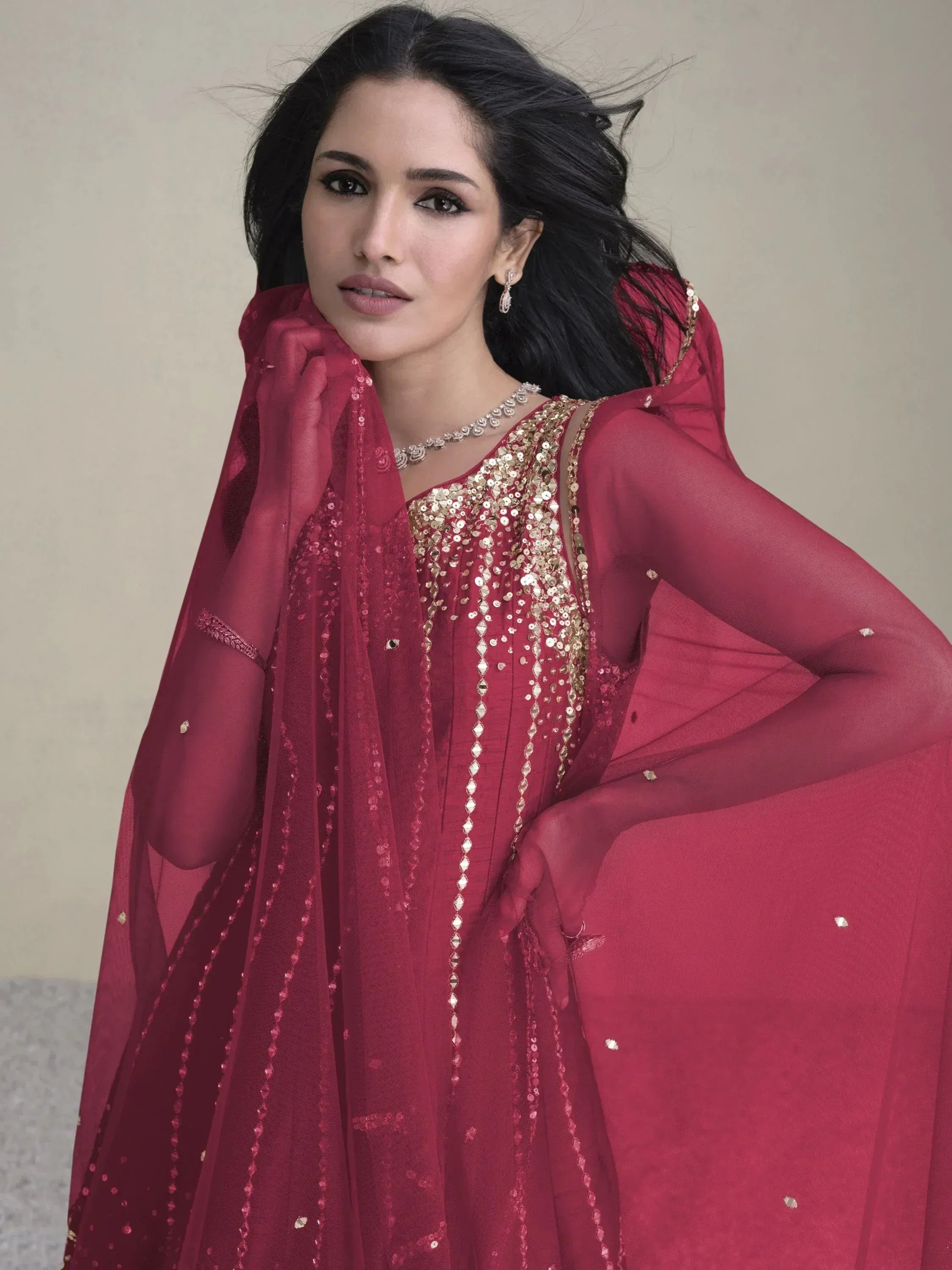 Elegant maroon ethnic gown with gold sequin embroidery and sheer dupatta, perfect for Indian celebrations