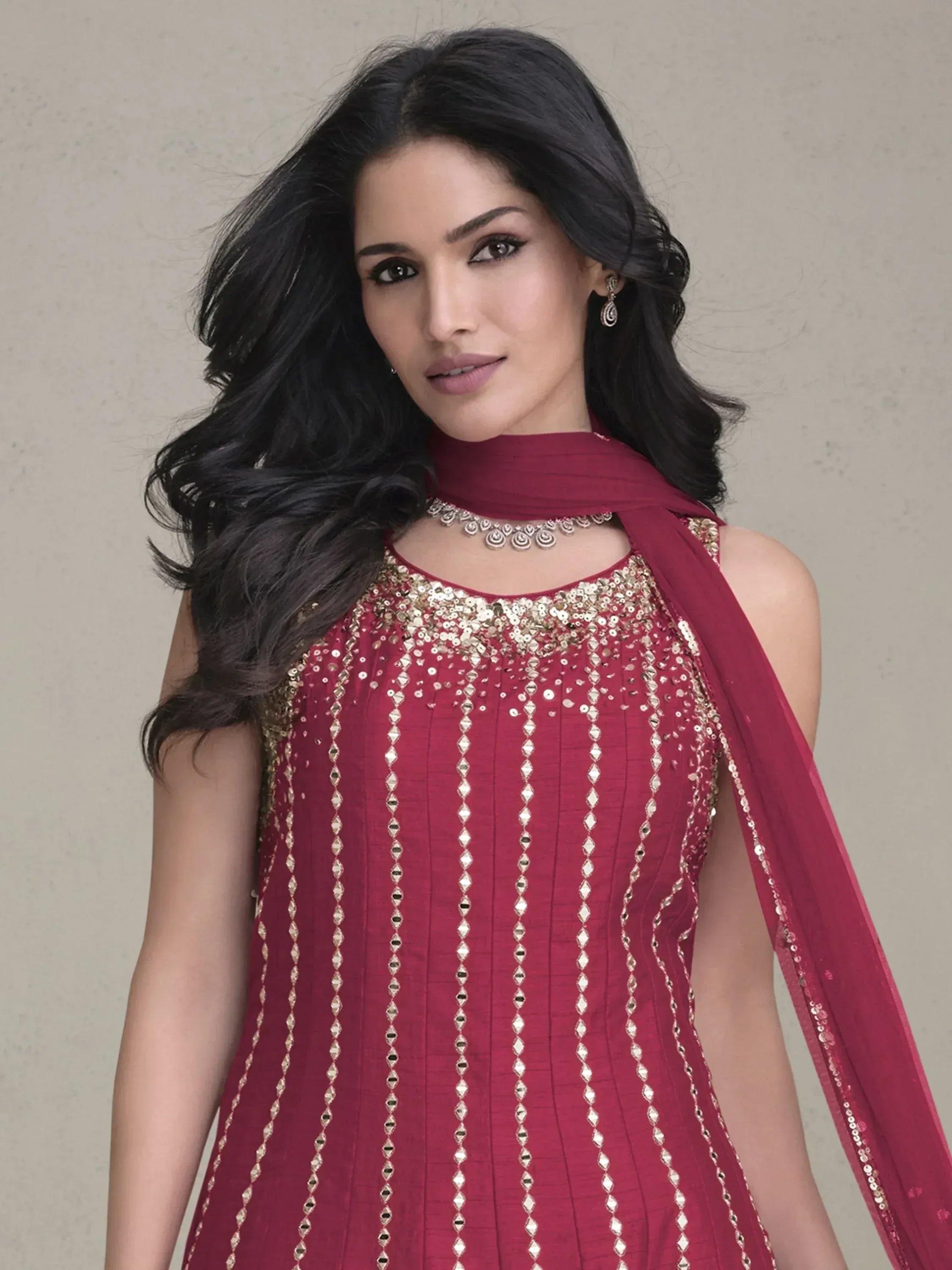 Maroon ethnic gown with gold sequin embroidery and matching dupatta, perfect for Indian festive occasions.