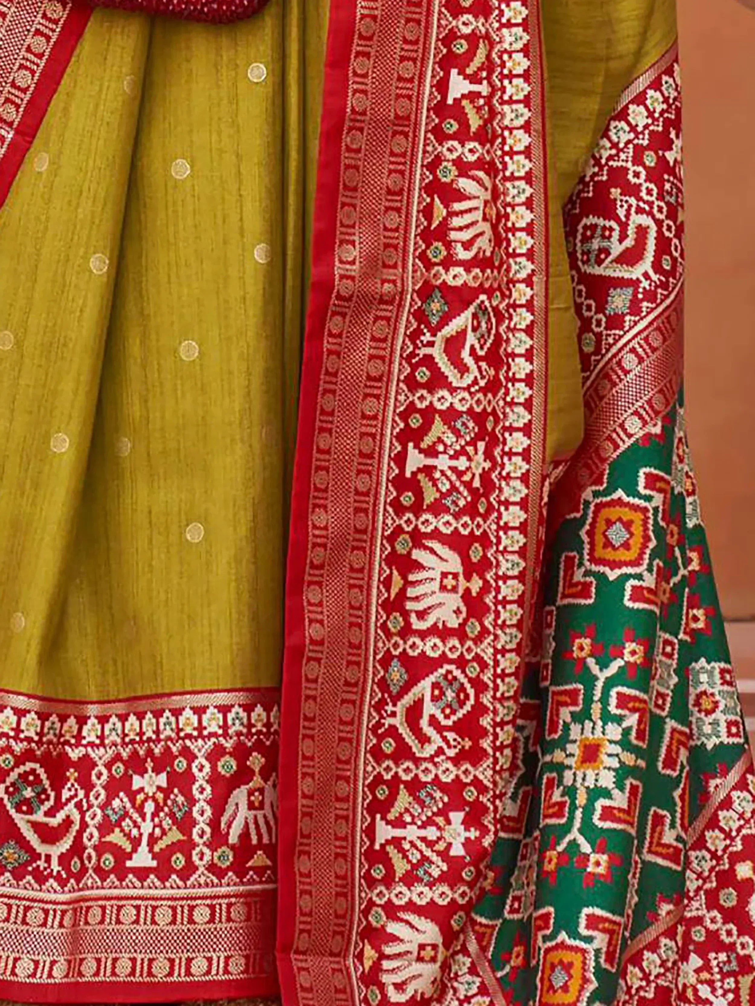 Yellow and red ethnic saree with intricate elephant and floral border patterns, traditional Indian wear