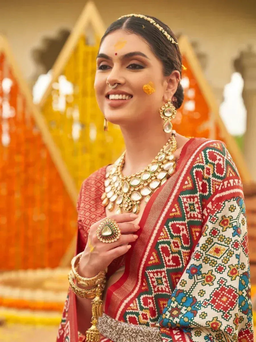 Woman in vibrant ethnic saree with gold jewelry, festive Indian attire for celebrations