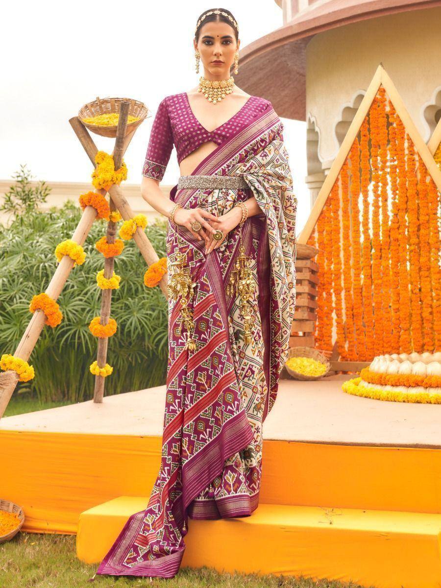 Elegant purple printed saree with gold jewelry, perfect for Indian ethnic occasions and festive events.