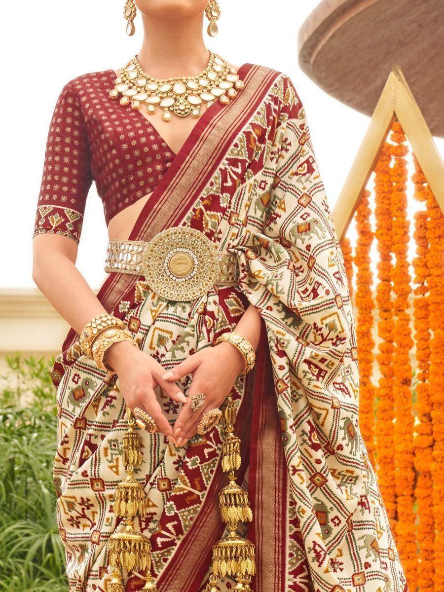 Elegant Indian ethnic saree with intricate patterns, gold jewelry, and traditional blouse for festive occasions