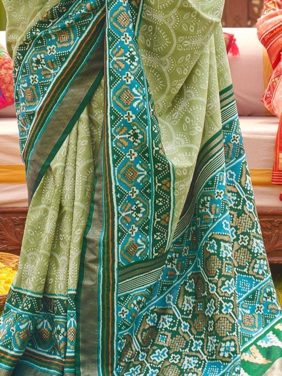 Green and blue printed saree with intricate ethnic patterns, perfect for traditional occasions