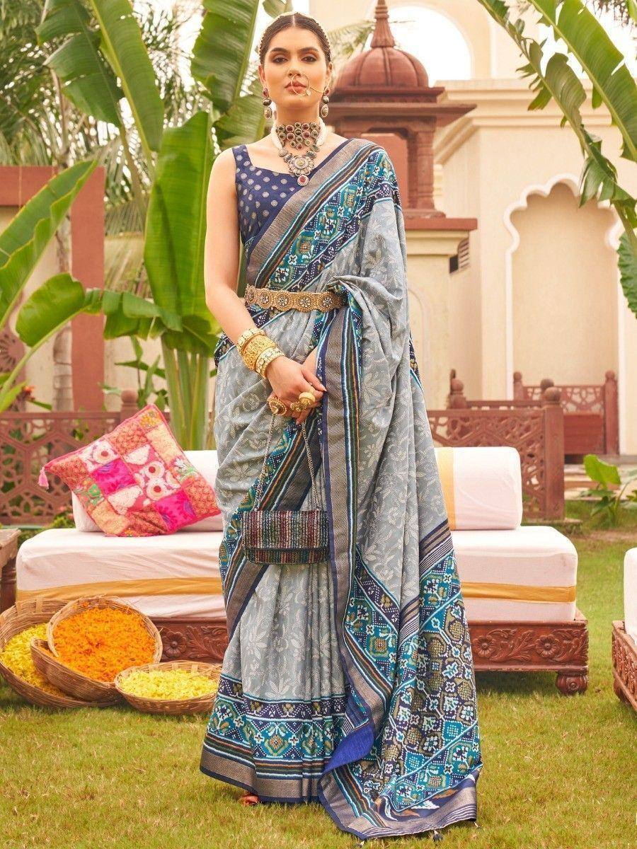 Elegant blue printed saree with ethnic jewelry and traditional decor for Indian festive wear