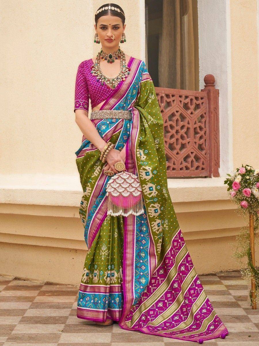 Vibrant green and pink ethnic saree with intricate patterns, perfect for Indian weddings or festive occasions.