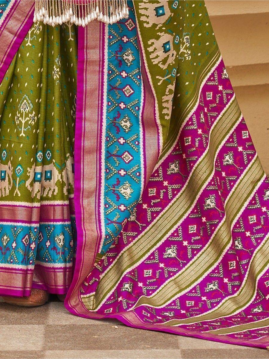 Vibrant Indian ethnic lehenga with green, pink, and blue Ikat patterns and elephant motifs