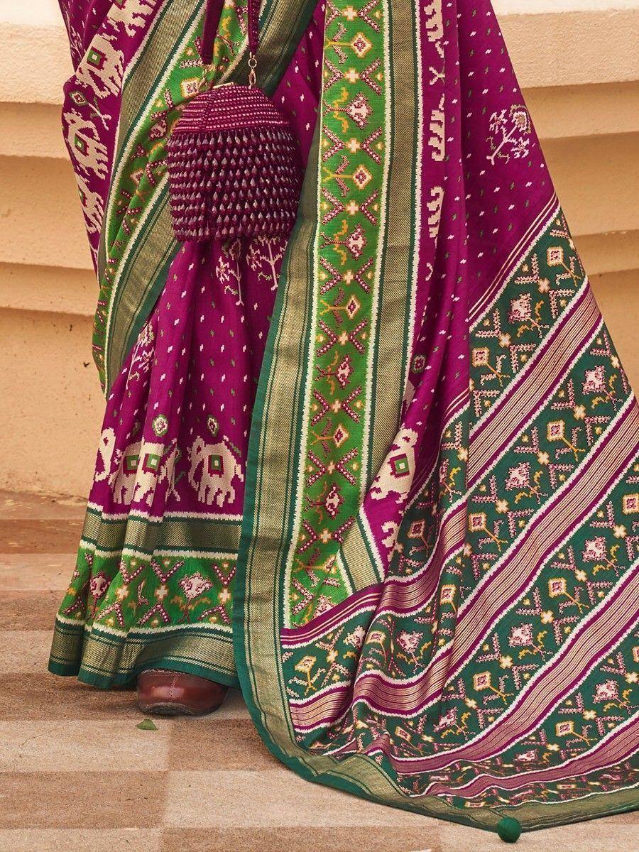 Vibrant purple and green ethnic saree with elephant motifs and intricate border patterns