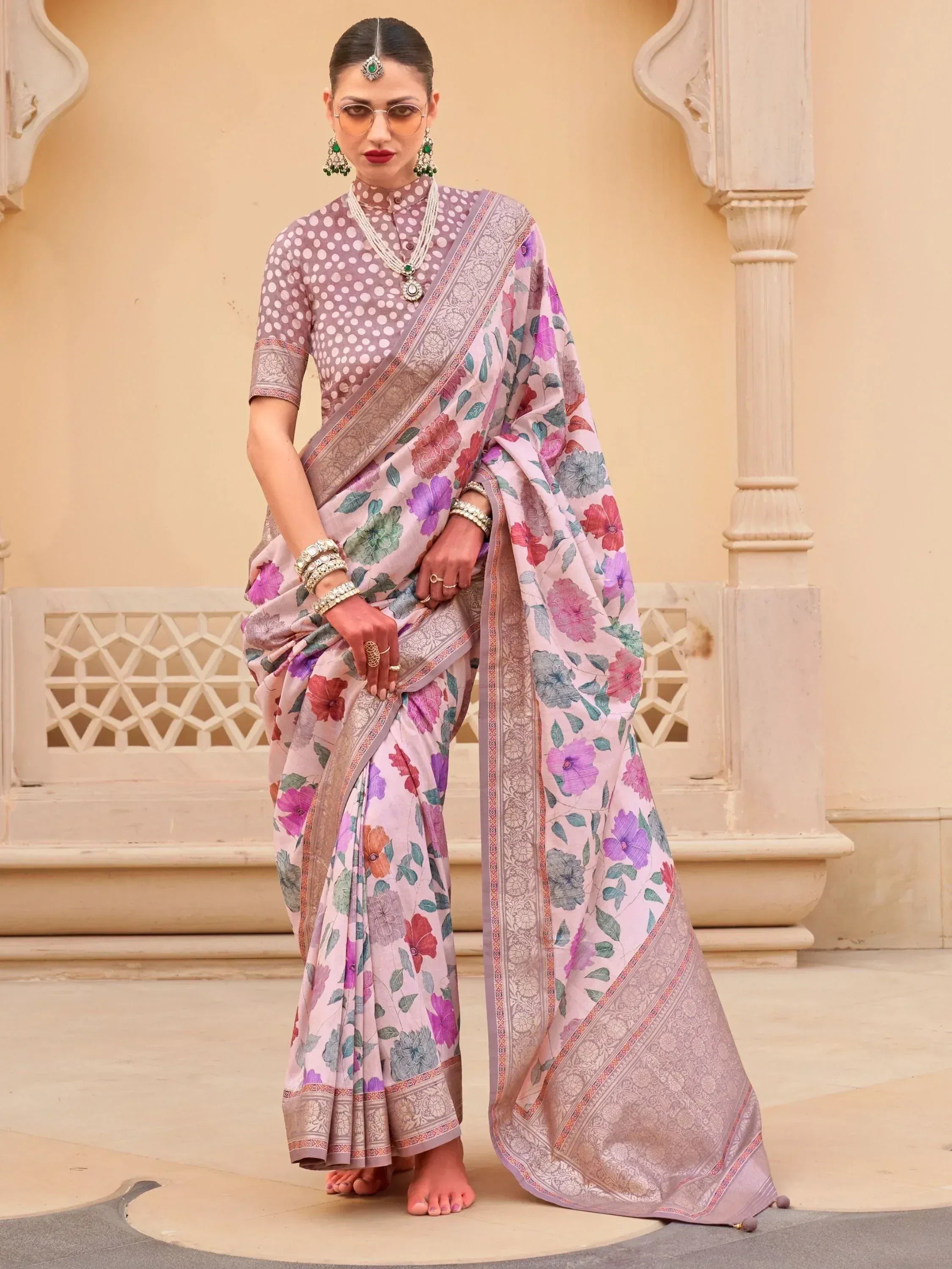 Woman in floral print saree with polka dot blouse, traditional Indian ethnic wear, styled with jewelry