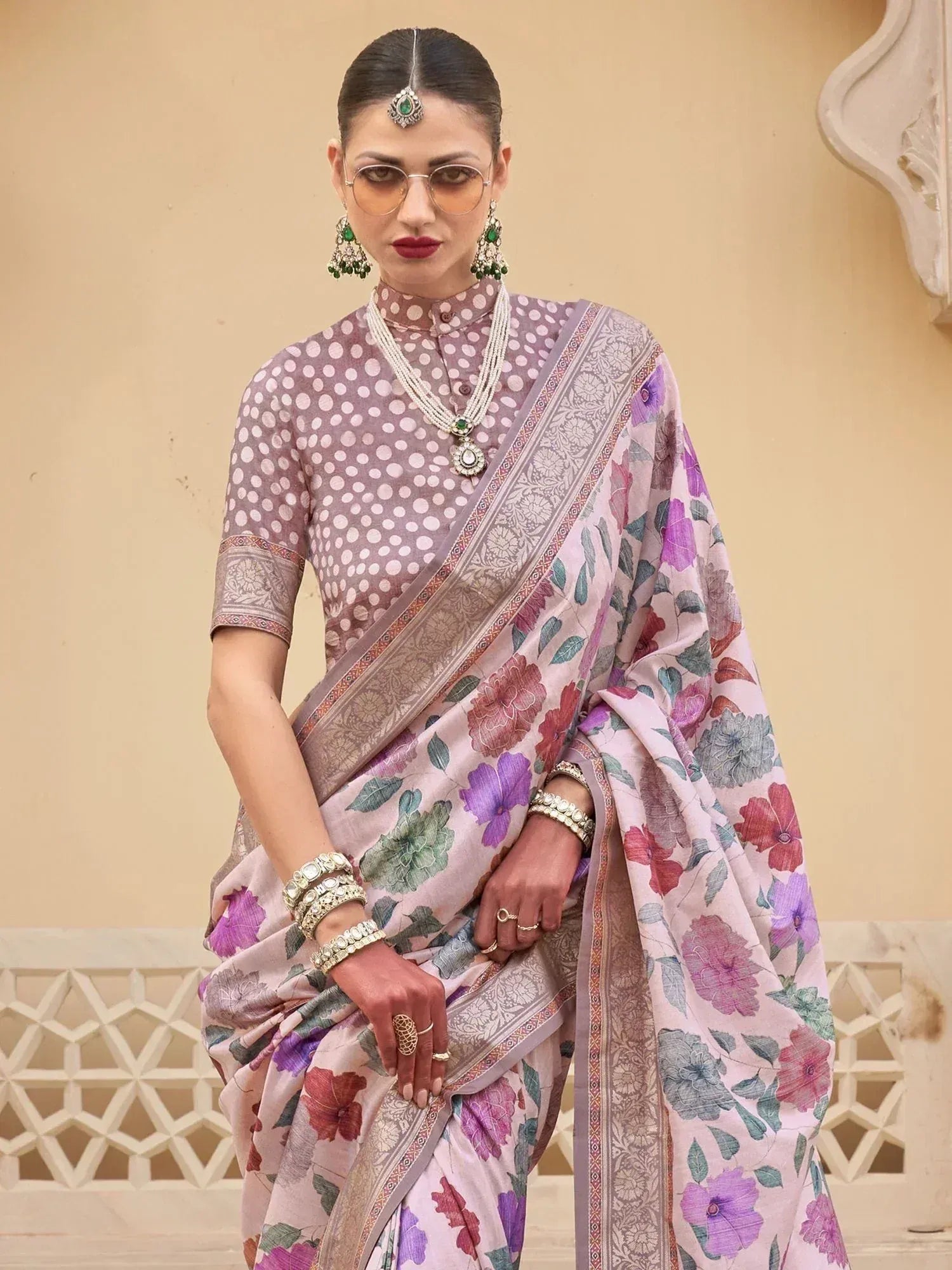 Woman in floral print saree with polka dot blouse, traditional Indian ethnic wear, styled with jewelry