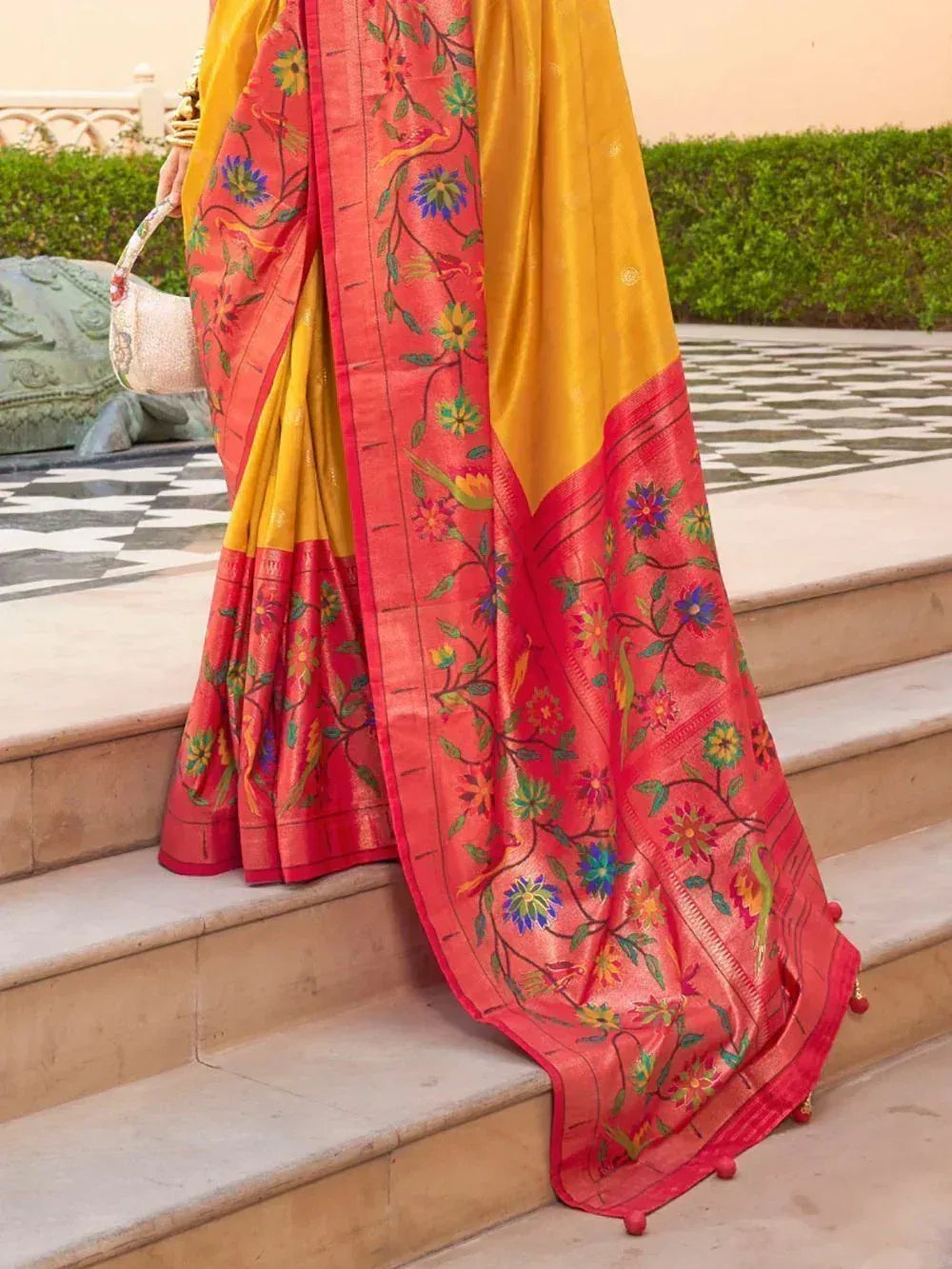 Vibrant yellow and coral saree with floral embroidery, perfect for Indian ethnic wear occasions.