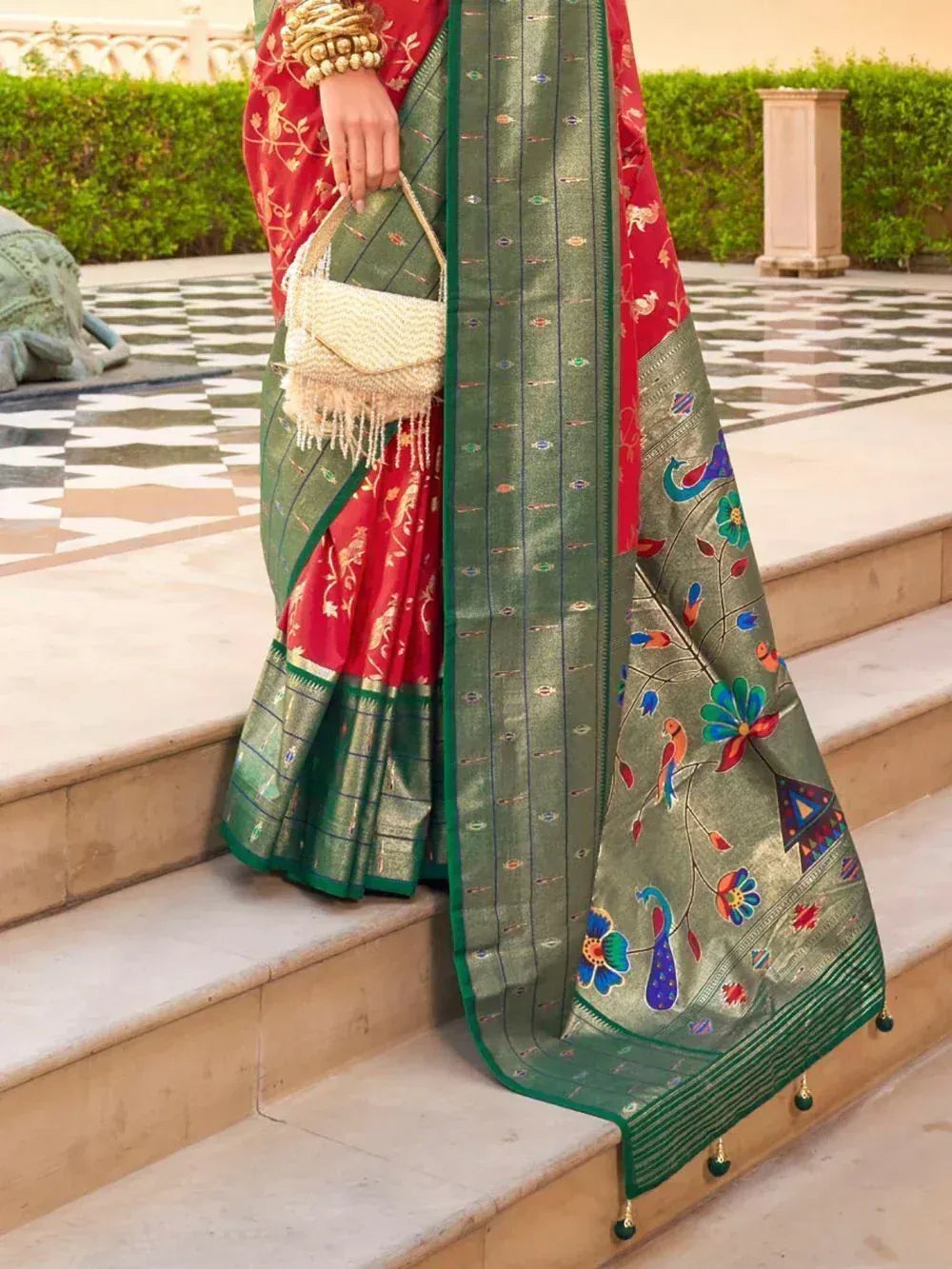 Red and green ethnic saree with peacock embroidery, perfect for Indian weddings and festive occasions.