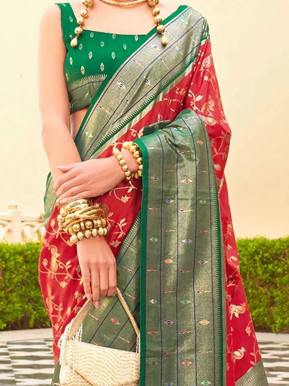 Red and green embroidered saree with gold jewelry, perfect for Indian ethnic wear occasions