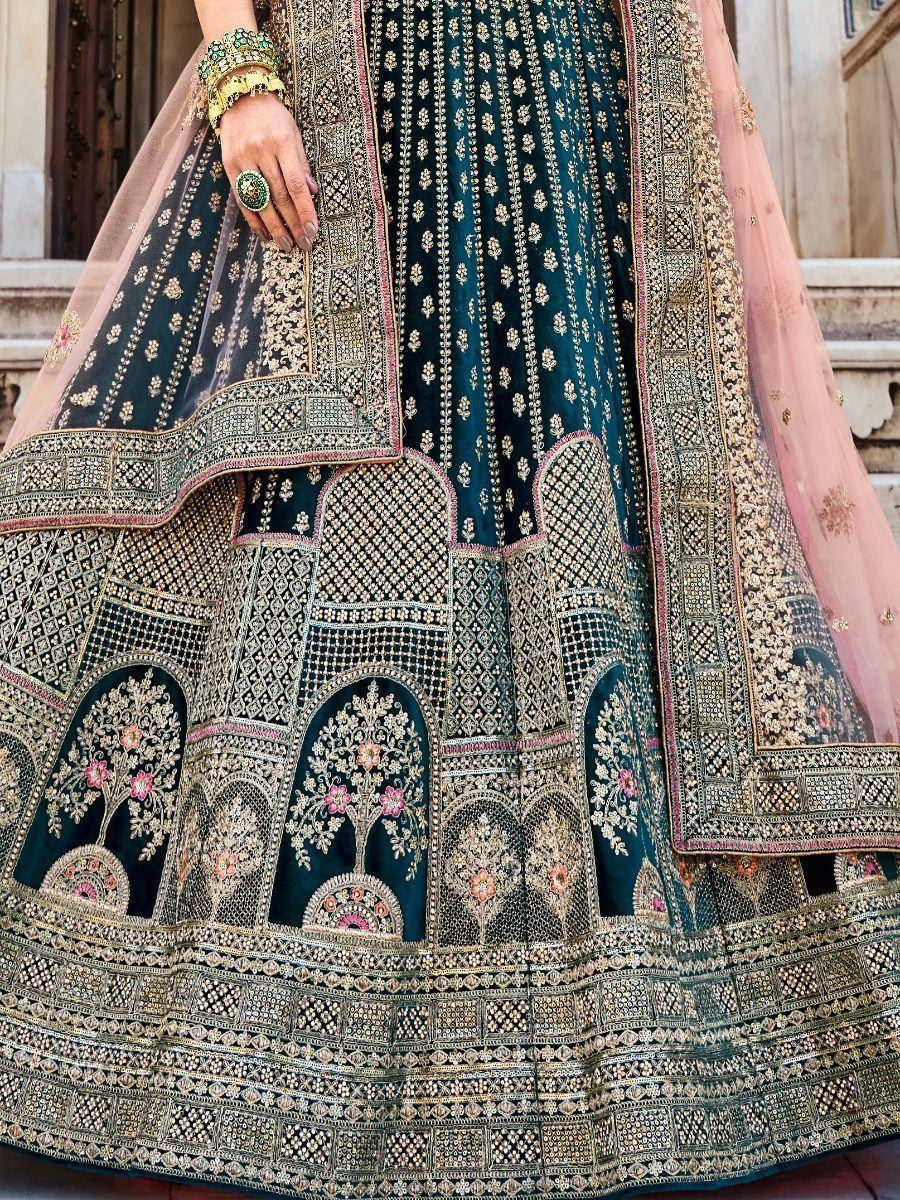 Teal designer lehenga with gold embroidery, floral motifs, and pink dupatta for Indian ethnic wear
