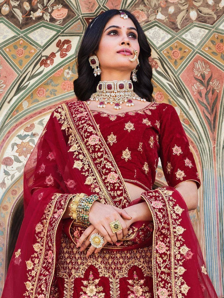 Maroon velvet lehenga choli with gold embroidery, perfect for Indian weddings and festive occasions