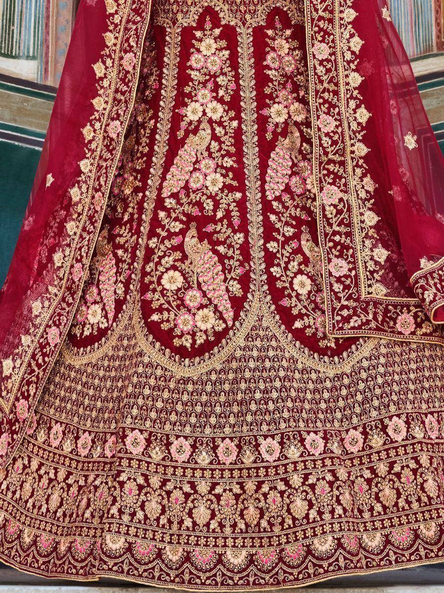 Maroon designer lehenga with gold and pink floral embroidery, perfect for Indian weddings and festive occasions.