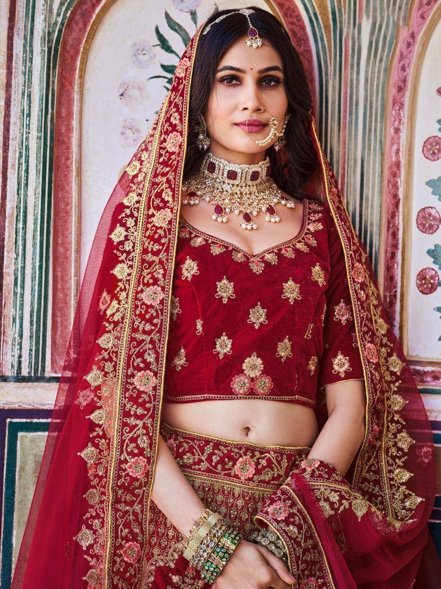 Red embroidered lehenga choli with gold detailing, perfect for Indian weddings and festive occasions.