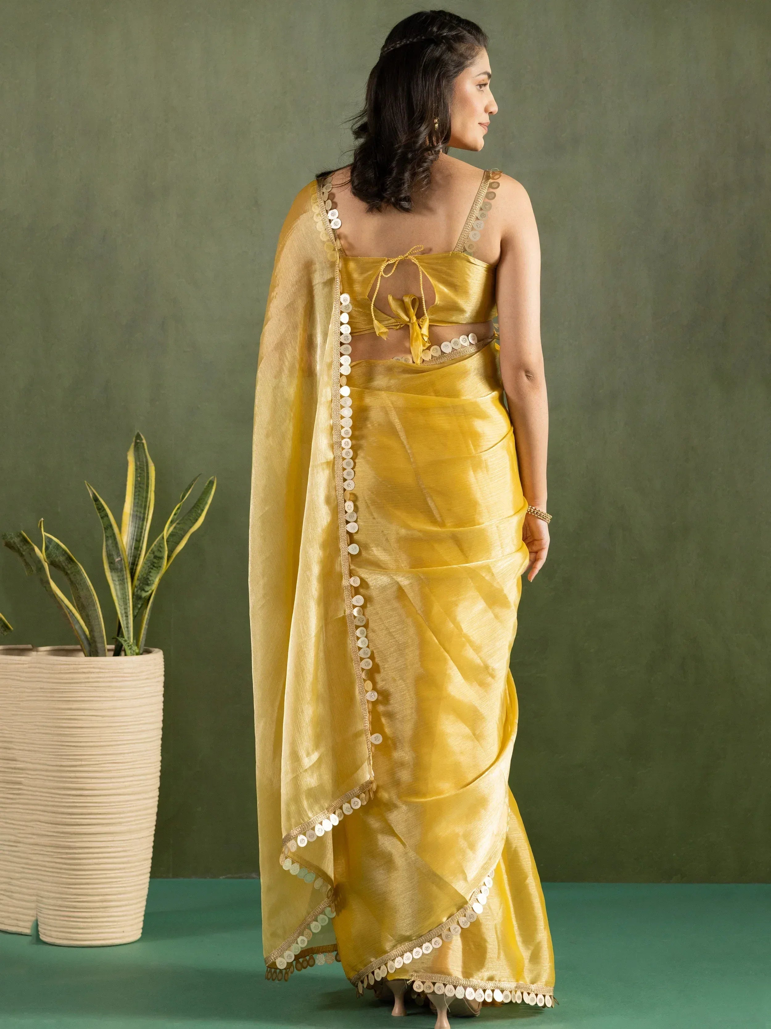 Yellow ethnic saree with sequin border and back tie blouse, styled for Indian occasions