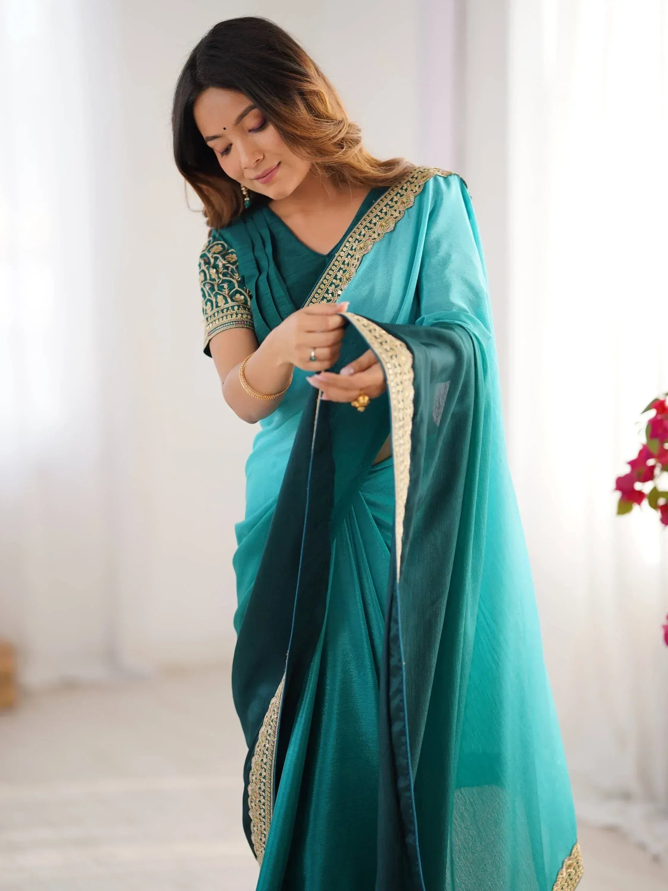 Teal designer saree with gold embroidery, perfect for Indian ethnic wear and festive occasions.