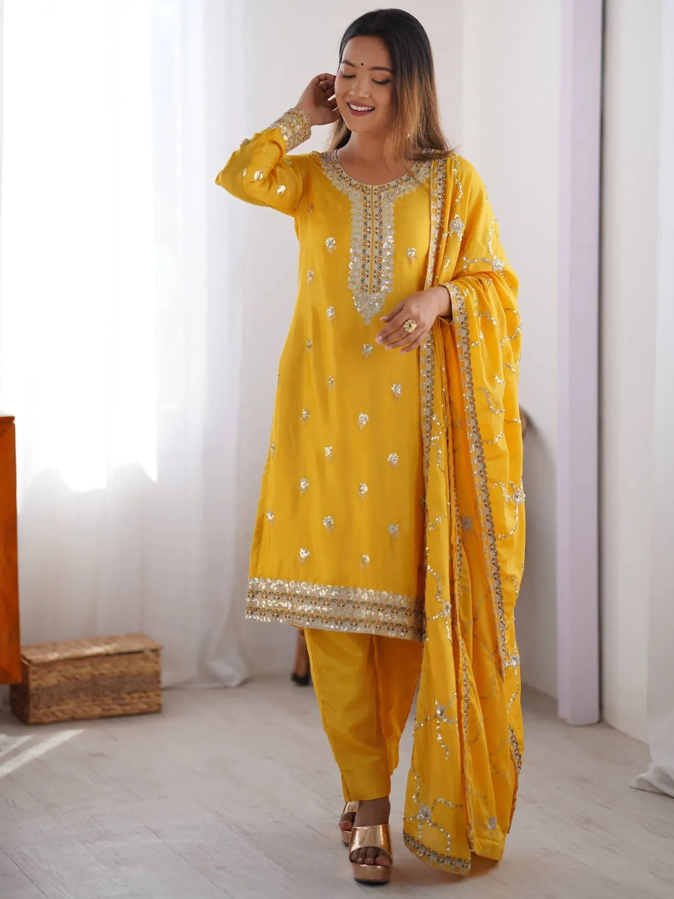 Yellow embroidered salwar kameez with matching dupatta, perfect for festive occasions