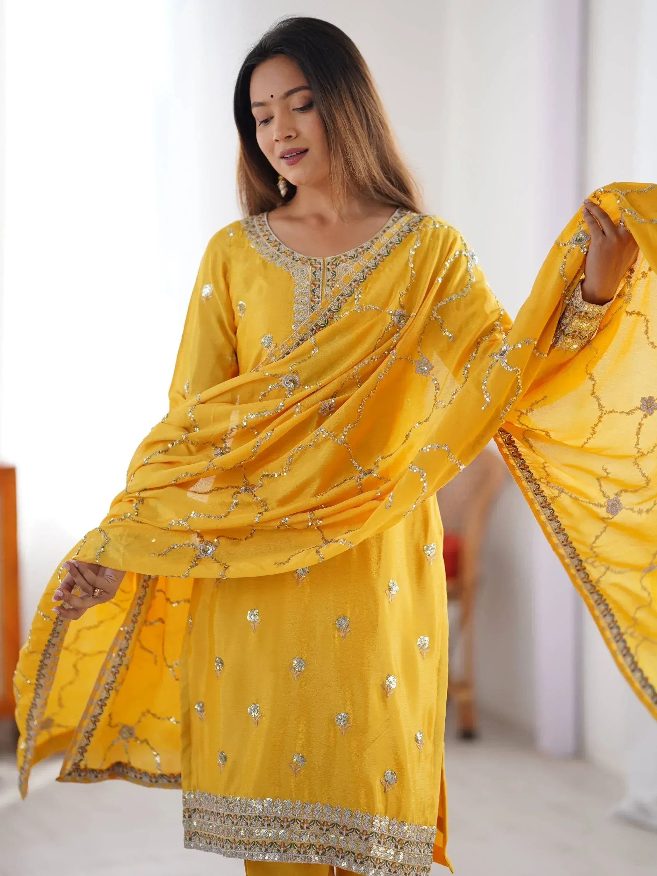 Yellow embroidered salwar kameez with floral sequin detailing, perfect for festive occasions.