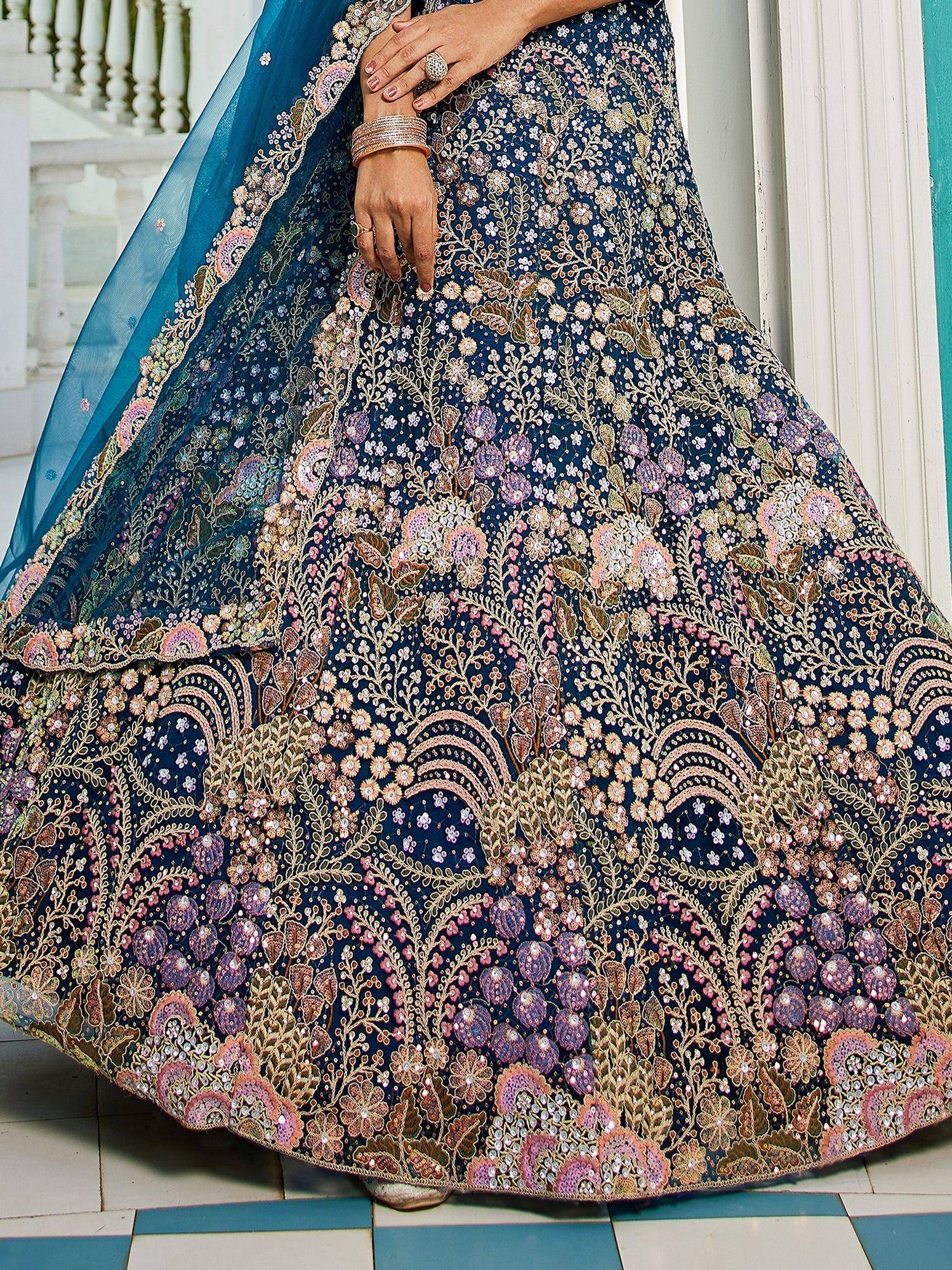 Blue floral embroidered lehenga choli with pink and gold detailing, perfect for Indian weddings and festive occasions.