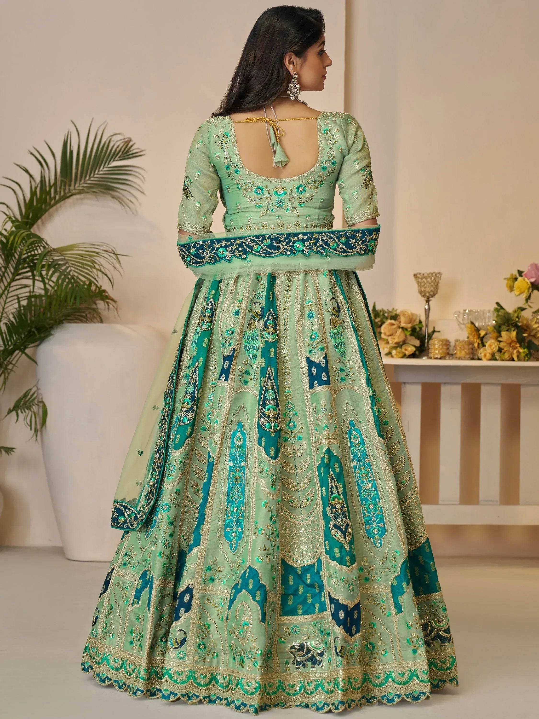 Mint green designer lehenga choli with peacock embroidery, perfect for Indian weddings and festive occasions.