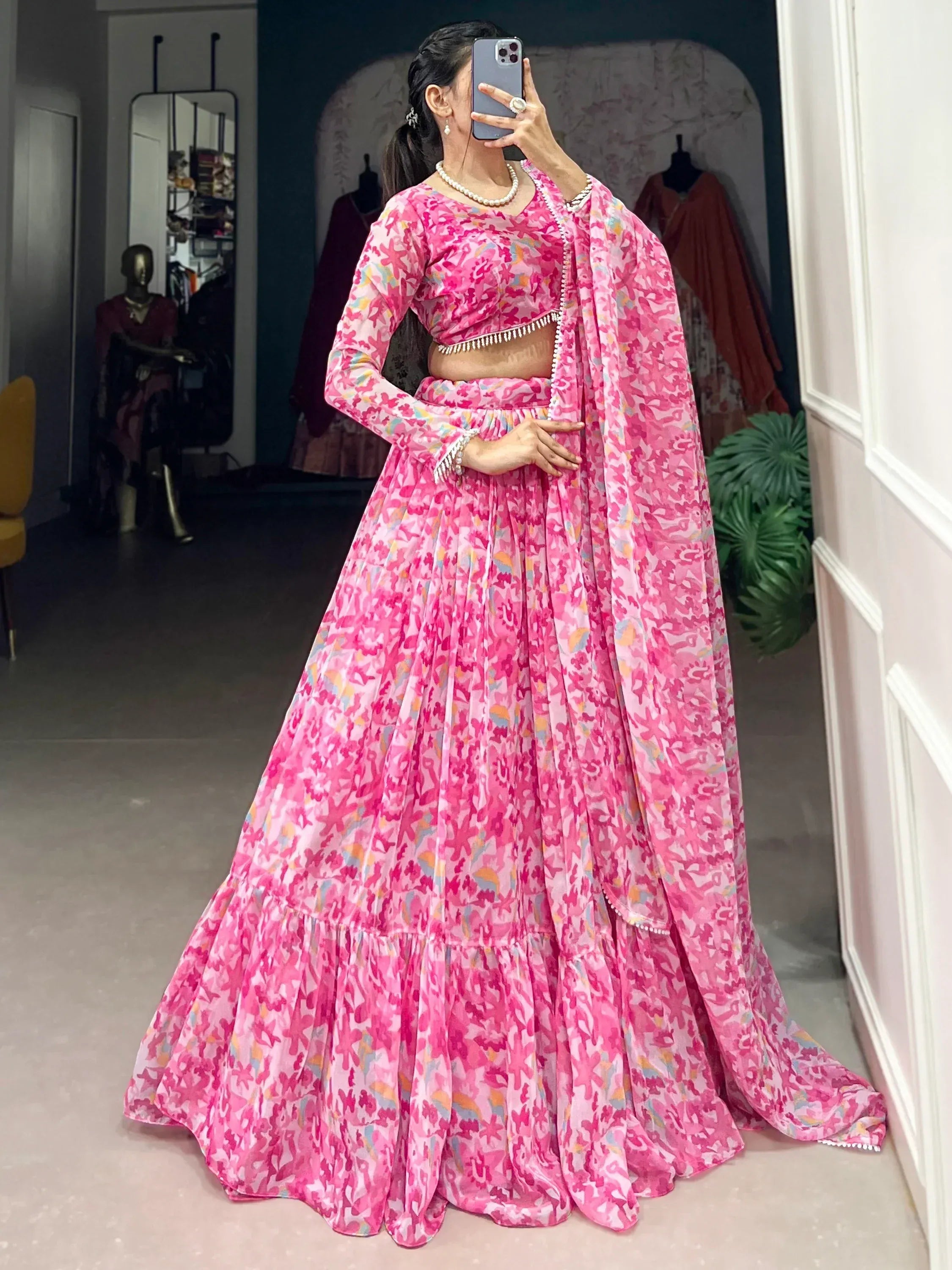 Pink floral print lehenga choli with long sleeves and pearl trim, perfect for Indian ethnic wear occasions.