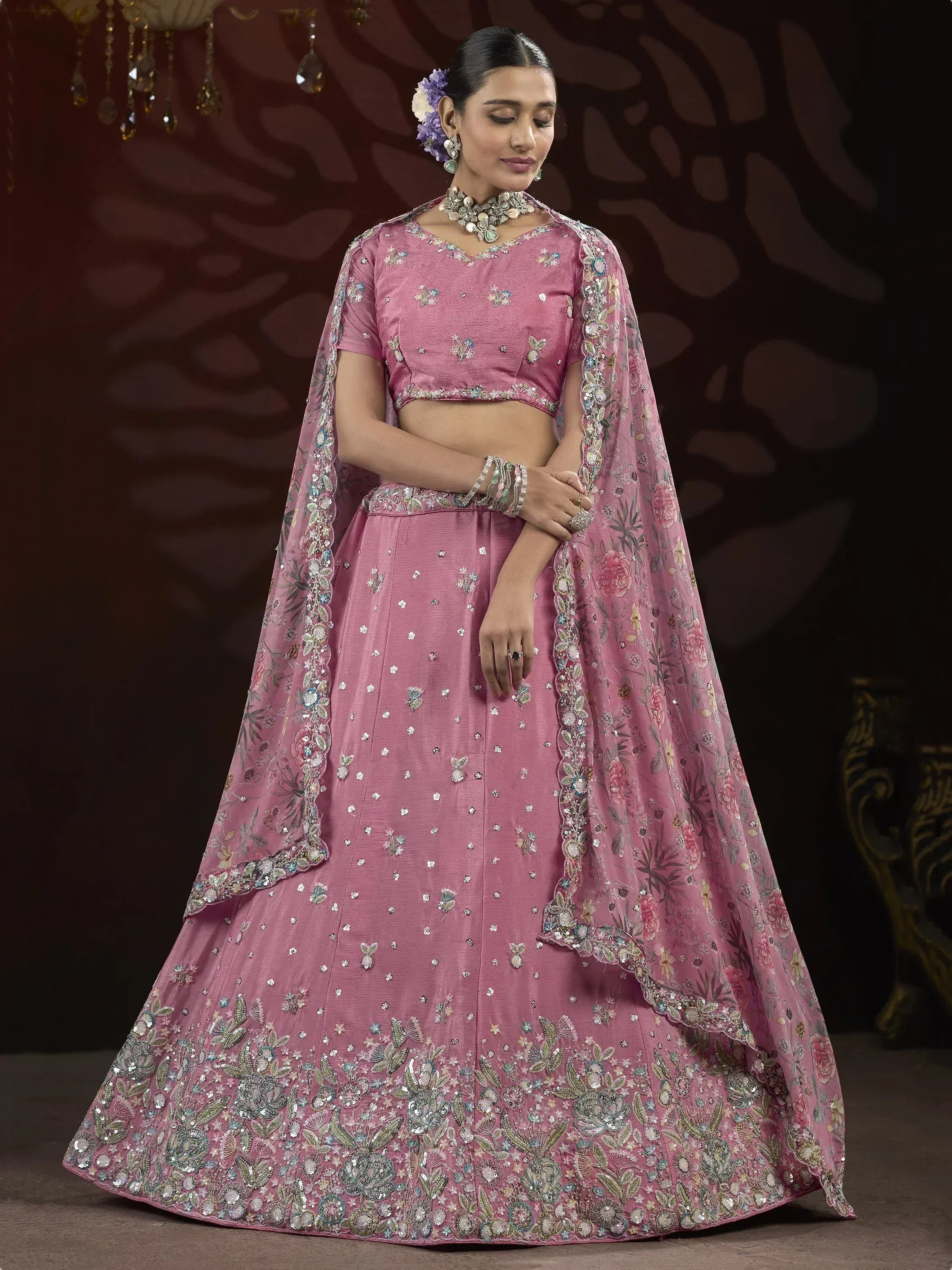 Pink designer lehenga choli with floral embroidery and sequins, perfect for Indian weddings and festive occasions.