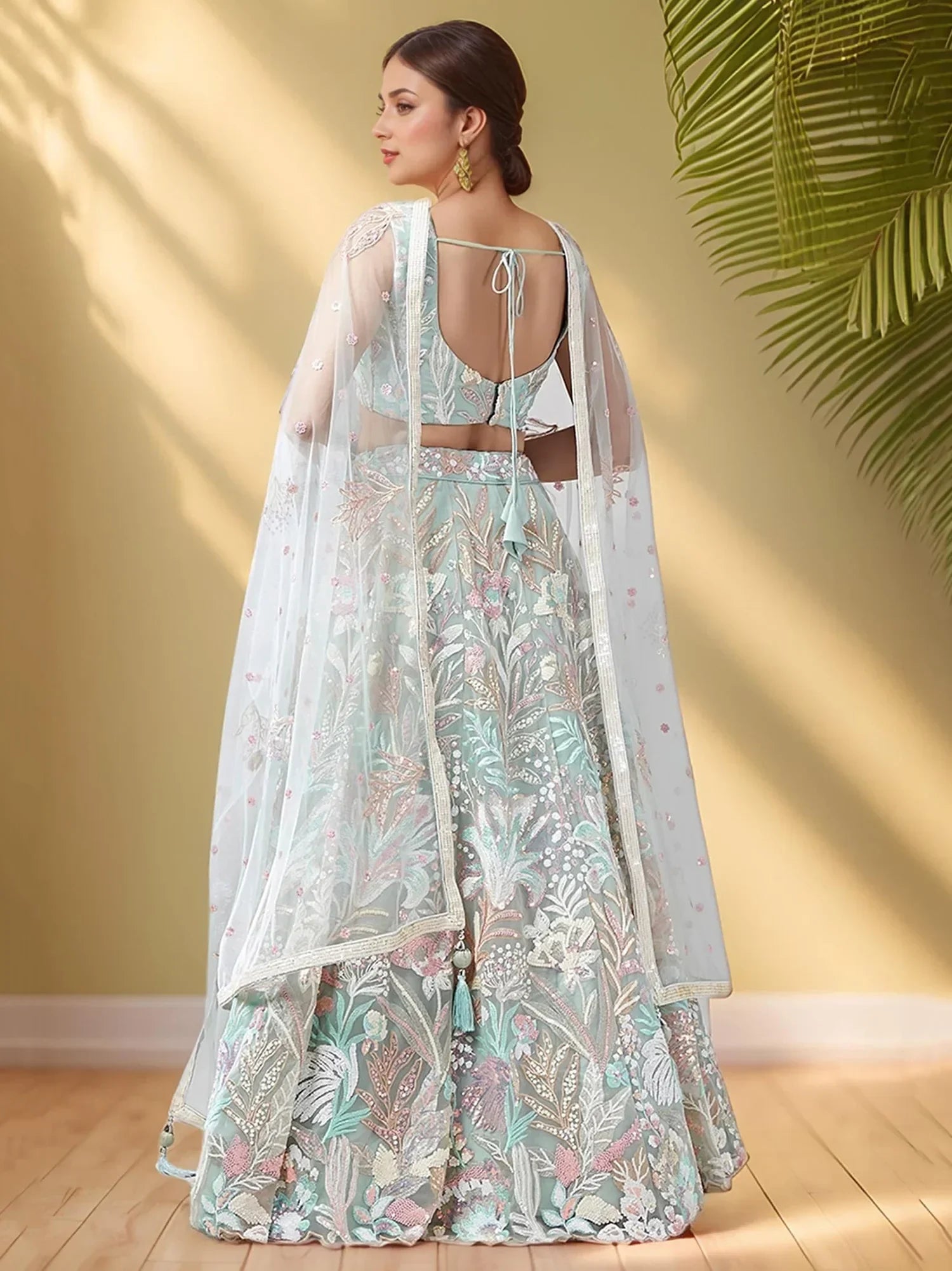 Mint green embroidered lehenga choli with floral motifs and sheer dupatta, perfect for Indian ethnic wear occasions.