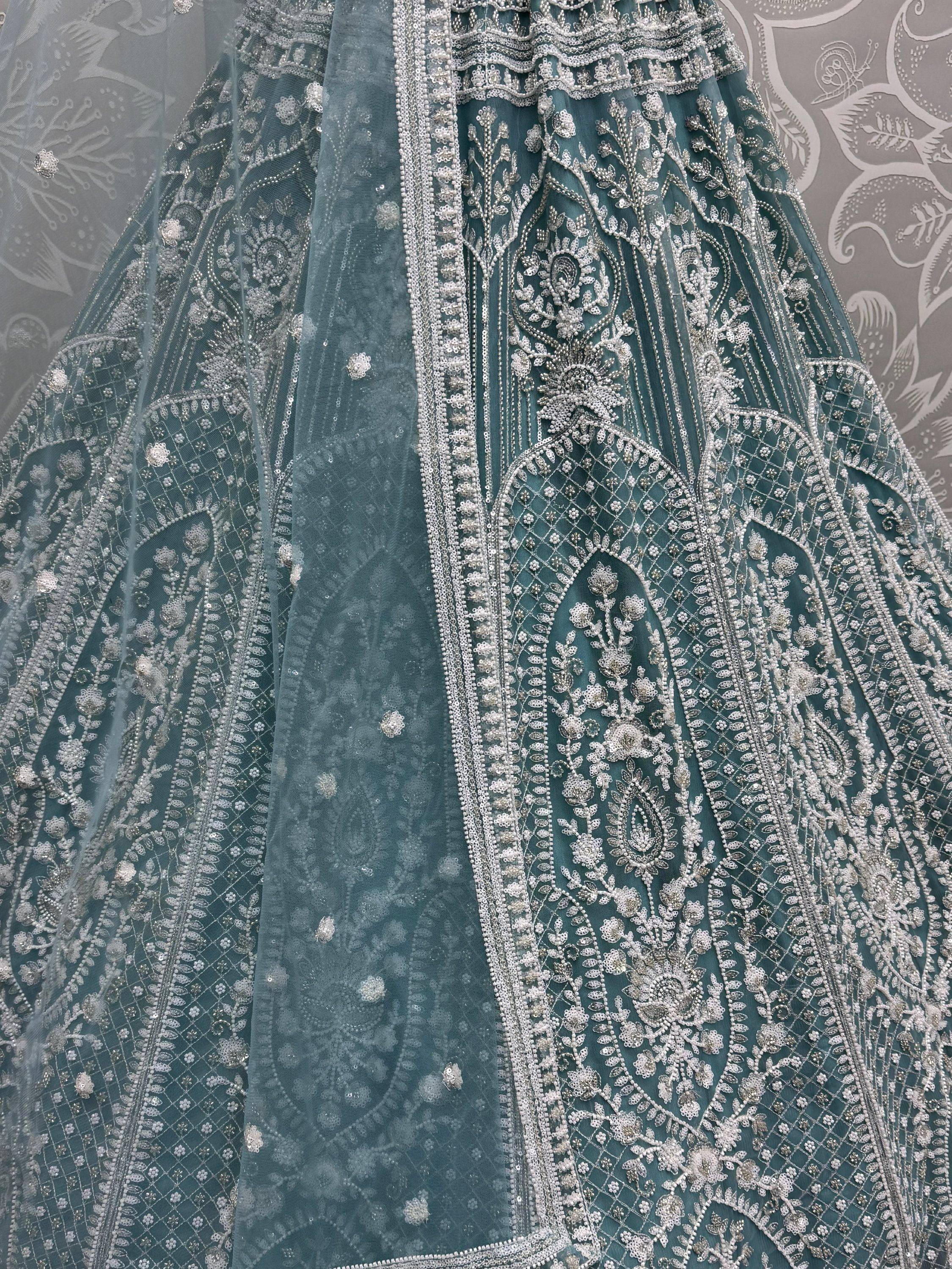 Teal Indian lehenga with intricate silver embroidery and beadwork, perfect for weddings and festivals.