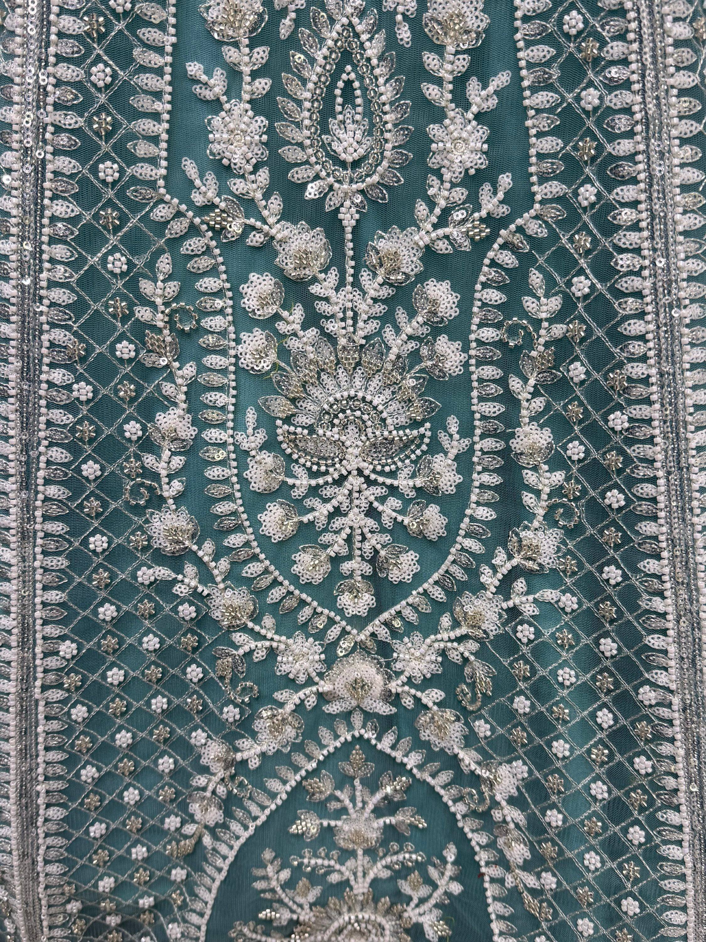 Teal ethnic wear with intricate silver floral embroidery and beadwork, perfect for designer lehenga or saree.